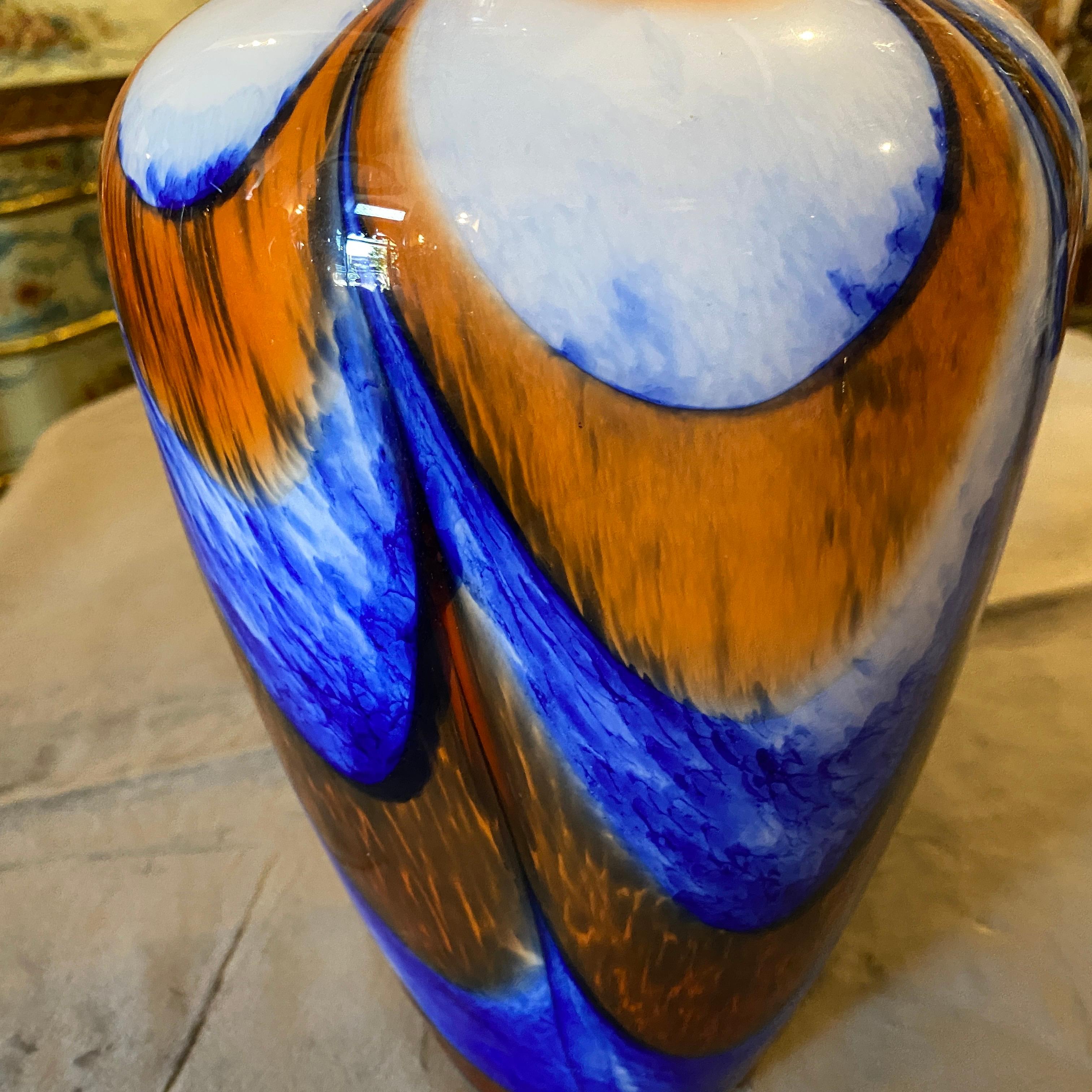 A stylish vase made in Italy in the Seventies by Carlo Moretti, vase it's in perfect conditions. This Vase is a stunning and vibrant example of Italian glass artistry from the iconic Murano glass-making region. Carlo Moretti, a renowned glassmaker,