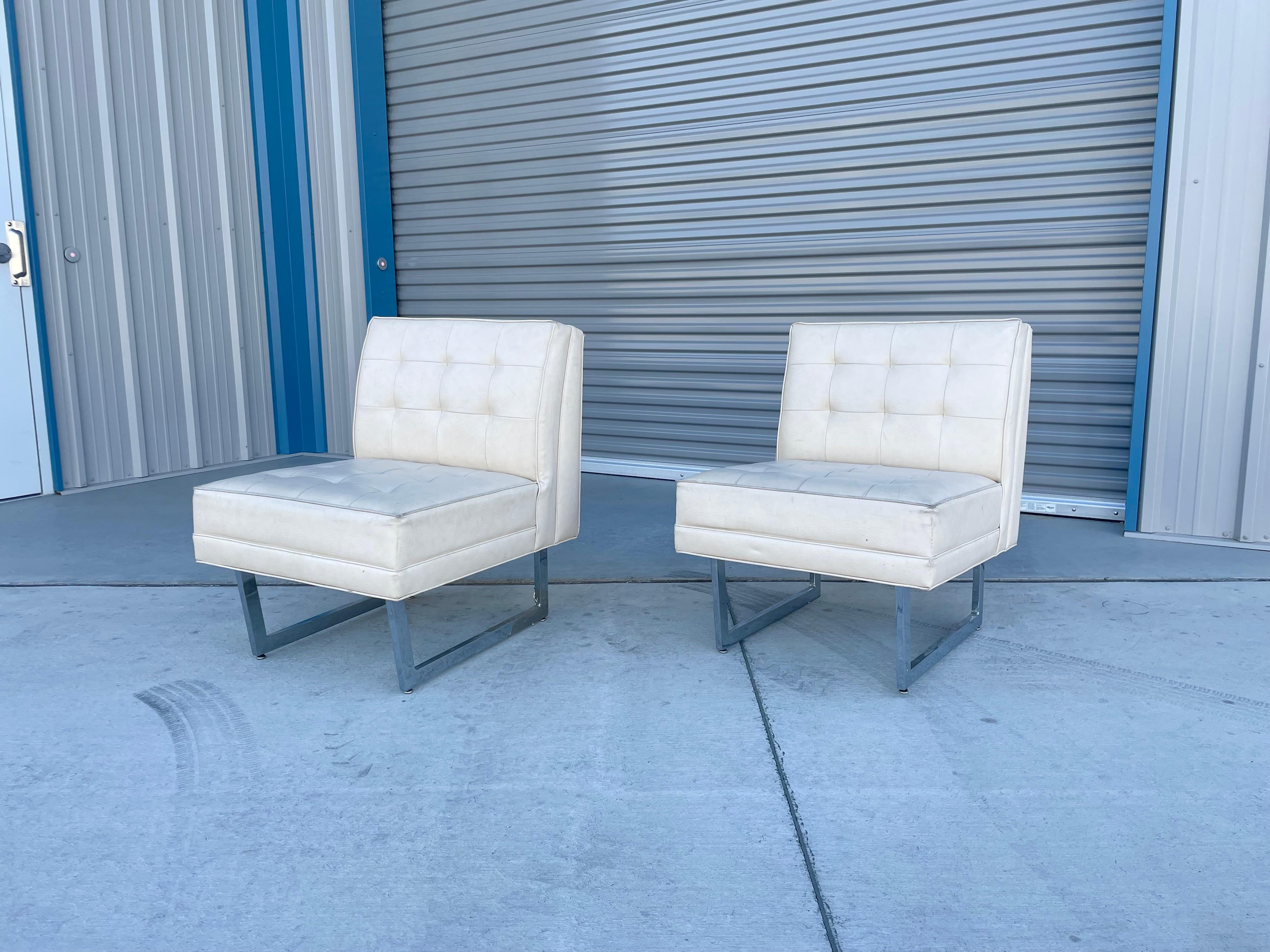 Mid-century chrome lounge chairs were designed and manufactured in the United States circa 1970s. This beautiful pair of lounge chairs features a leather upholstery that sits on top of two chrome legs. This remarkable pair of lounge chairs showcase