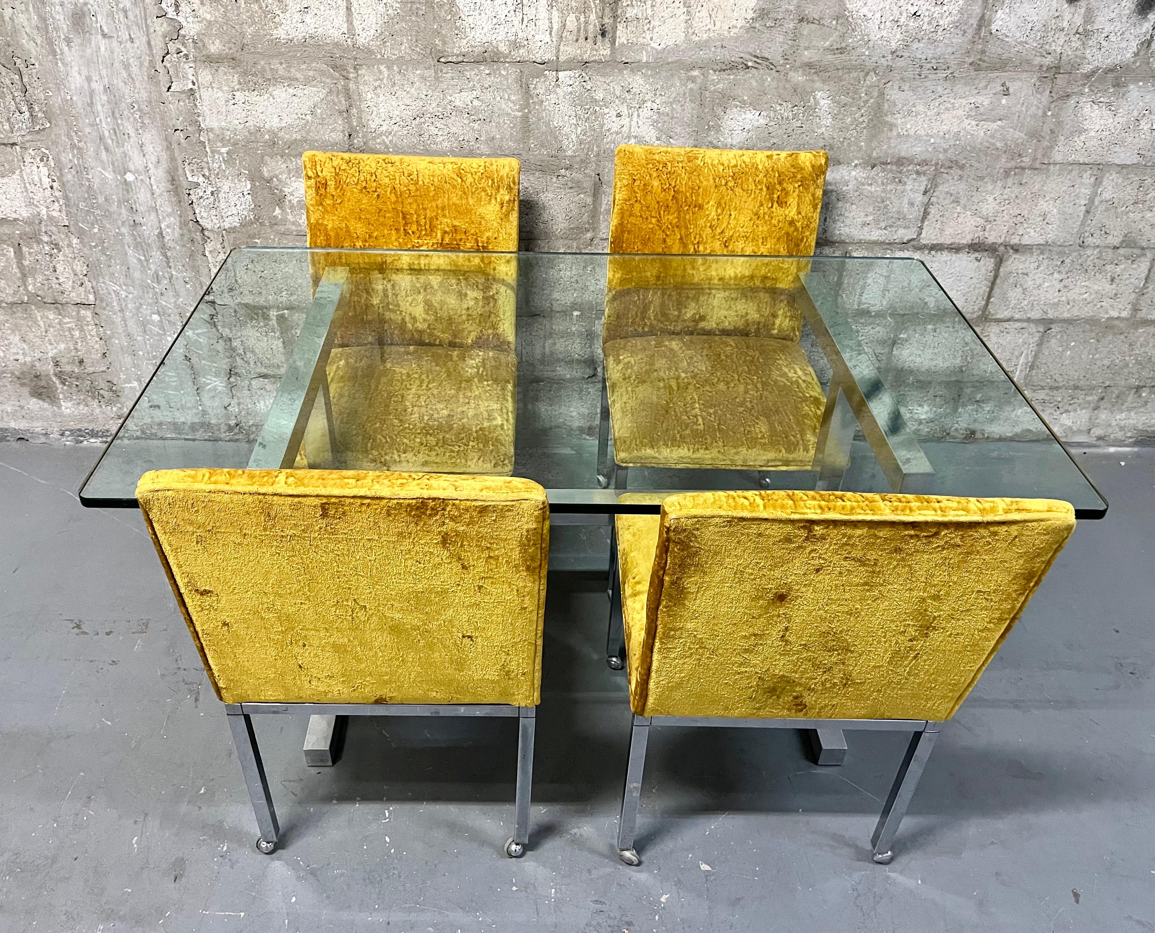 Vintage Mid Century Modern Chrome Dining Room Set in the Milo Baughman Style manufactured by Scancraft Furniture, NY. Circa 1970s.
The Table Features a polished aluminum frame with a quintessential 1970s minimalist design topped with a 1/2