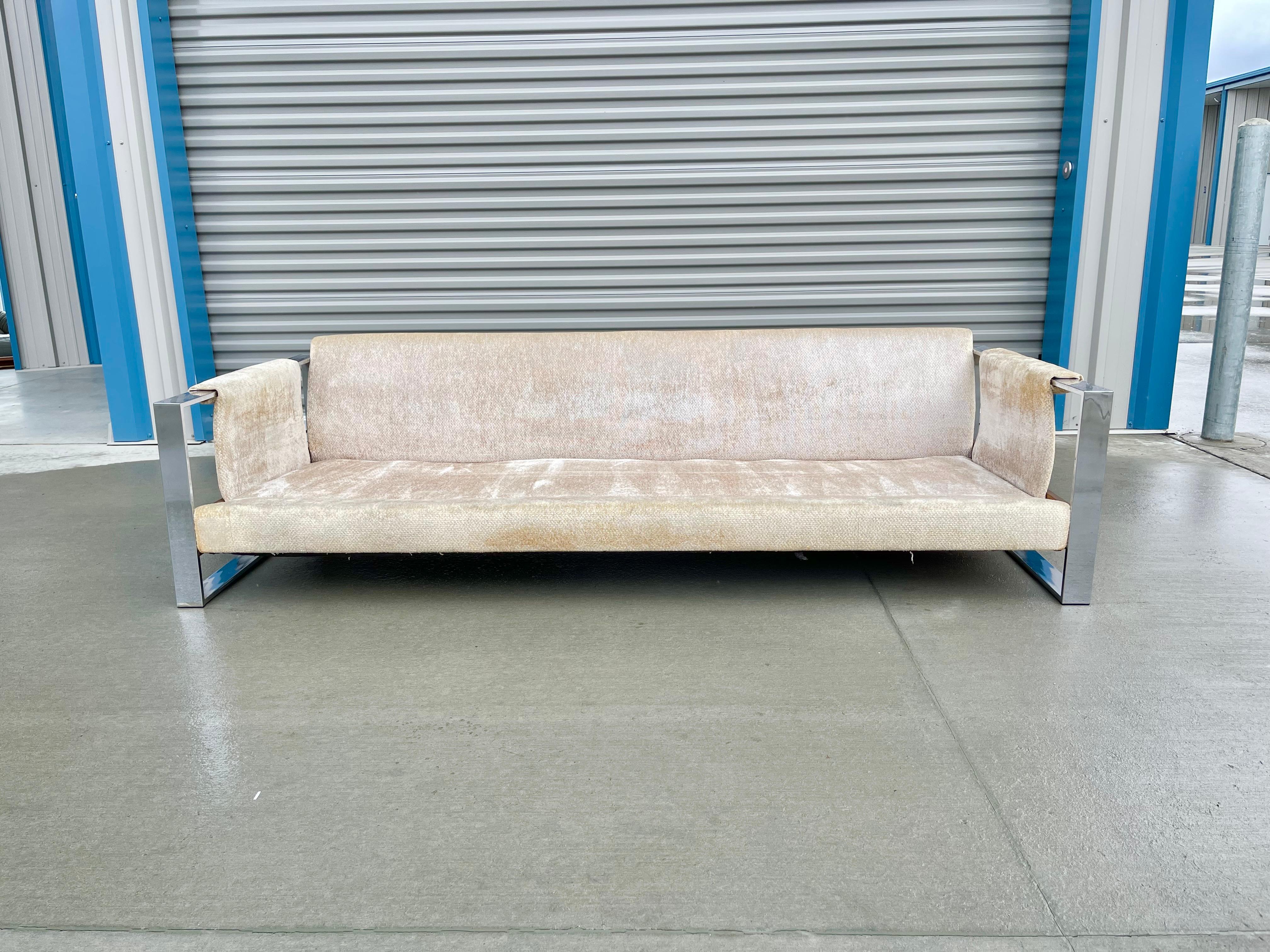 Mid-century modern chrome sofa designed by Adrian Pearsall and manufactured by Craft Associates in the United States circa 1970s. This beautiful sofa features two square chrome legs, giving it the illusion that it's floating, the sofa does need to