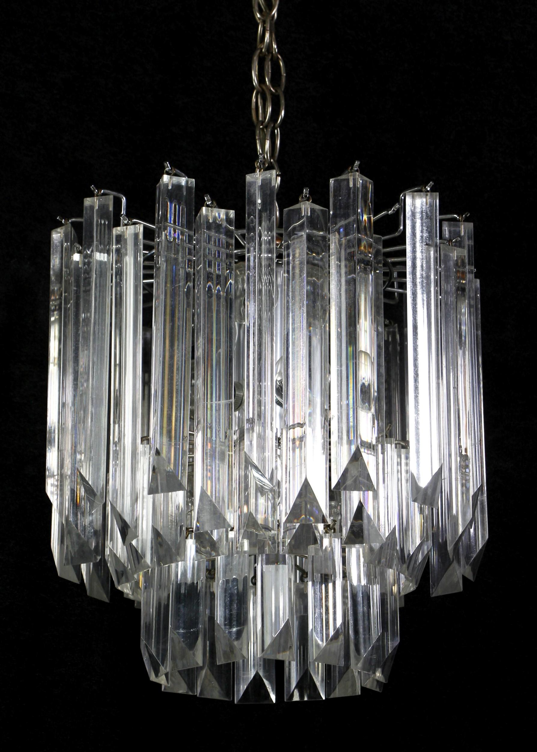 1970's Three-tier Lucite chandelier with clear prisms and chromed metal frame. This Mid-Century chandelier has provides a warm glow. Price includes restoration.

 