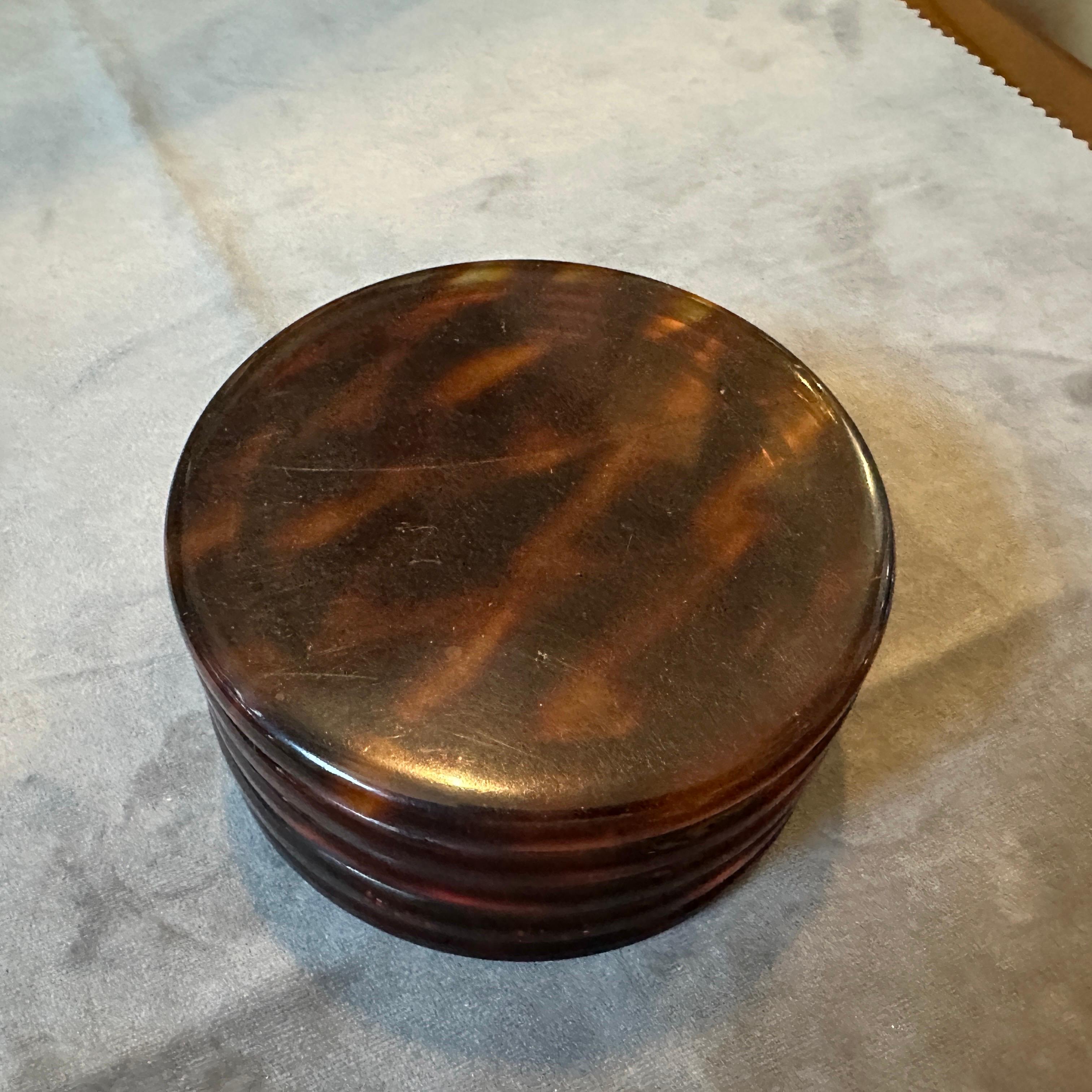 This lucite jewelry box designed and manufactured in Italy in the Seventies embodies the mid-century modern style with its sleek, minimalist form and use of synthetic materials. The faux tortoise shell finish provides a glamorous and timeless look,