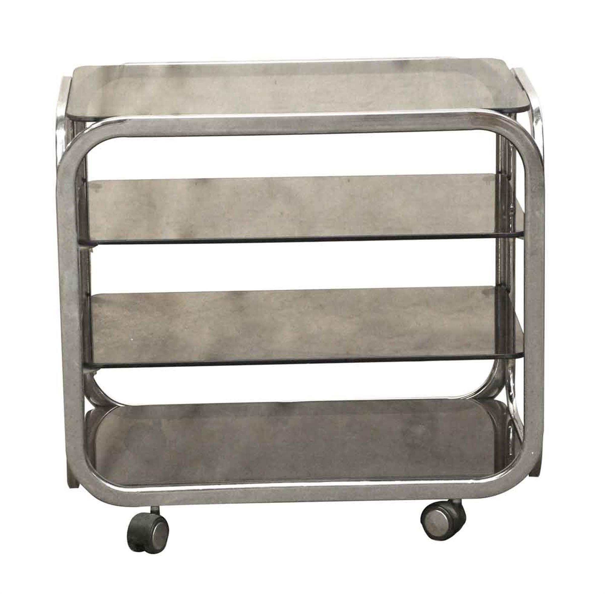 French 1970s chrome-plated wheeled bar cart with four smoked glass tiered shelves done in a Mid-Century Modern styling. This can be seen at our 400 Gilligan St location in Scranton, PA.
