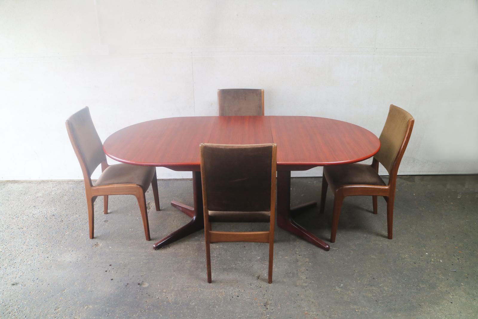 A large G Plan extending dark teak dining table with very elegant set of original G Plan dining chairs upholstered in the original brown velour fabric.
 