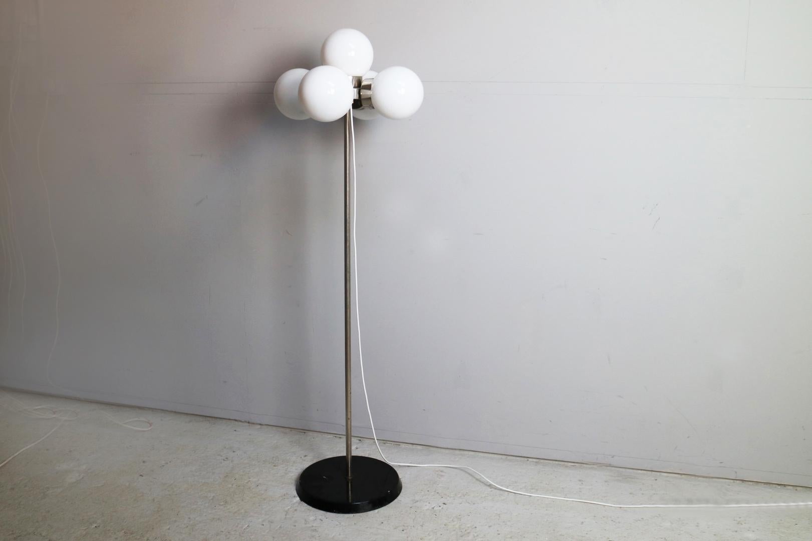 A lovely example of midcentury lamp design. 5 white glass globes sit in chrome fitments around a central chromed pole, with a black painted base. Solid and very well made.