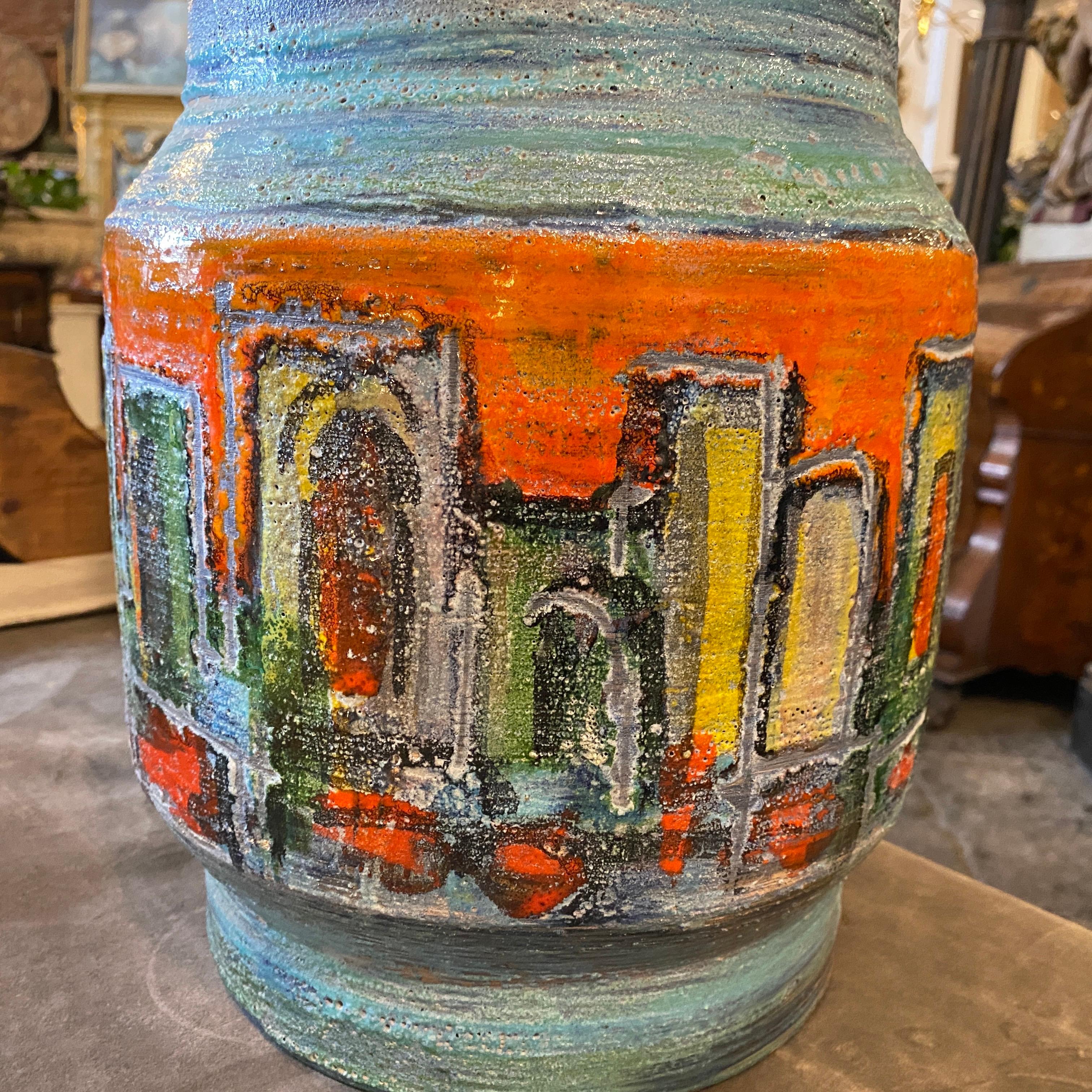 A modernist huge vase hand-crafted and hand-painted in Germany in the Sixties, signs of use and age. It's a vibrant and distinctive piece of functional art, this ceramic umbrella stand embodies the essence of the era's design sensibilities. Standing