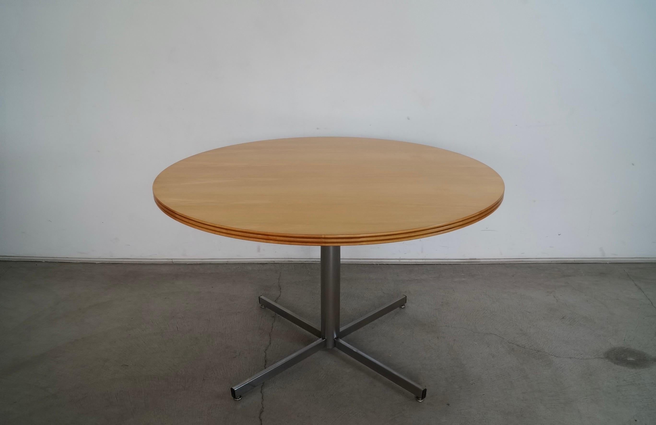 Vintage Midcentury Modern dining table for sale. Has a chrome star pedestal base, and a round natural wood top. The top has been professionally refinished, and is in excellent refinished condition. The chrome has been polished, and is in great
