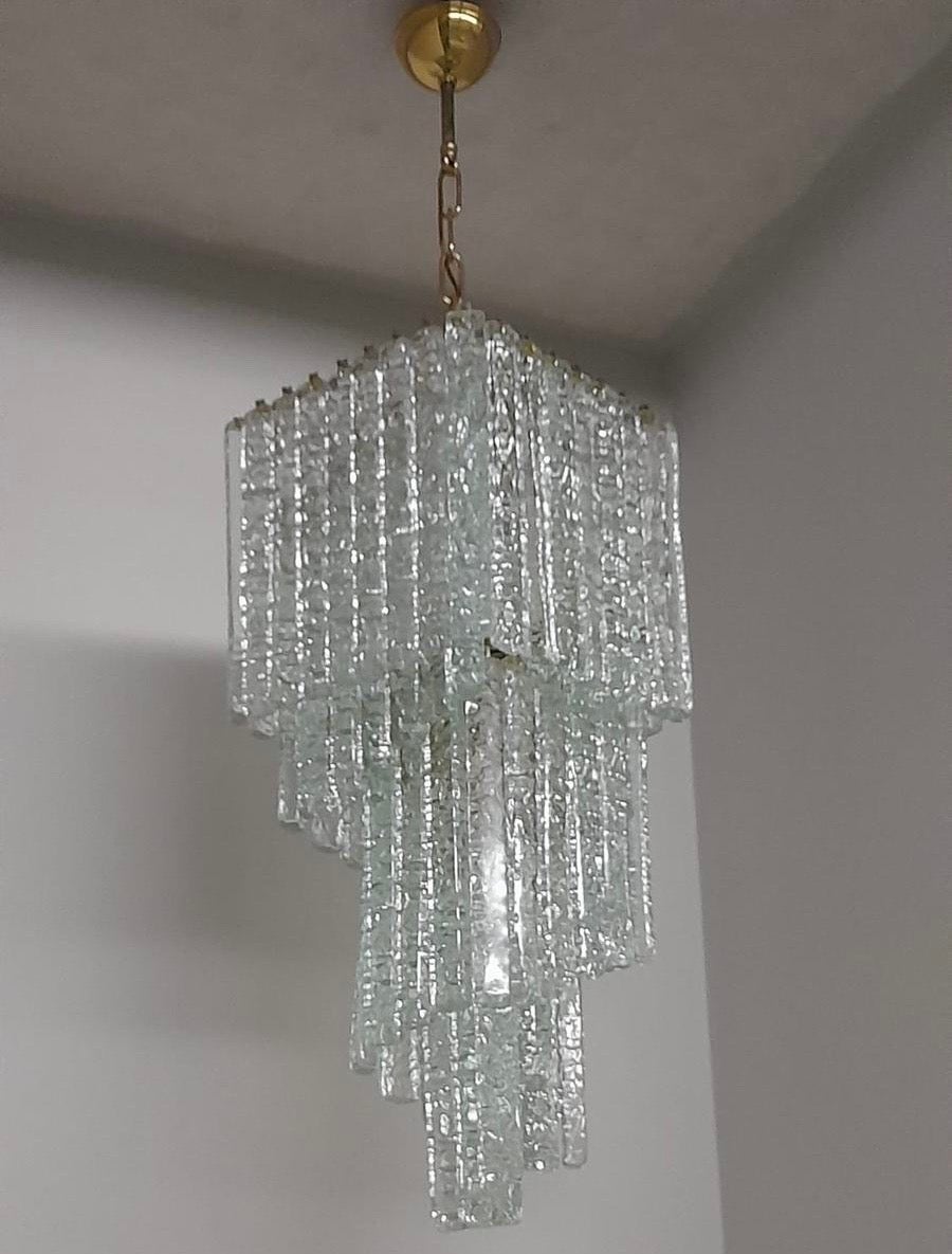 An amazing square spiral chandelier designed and manufactured in Murano by Mazzega, the chandelier has been never used in a house, it came from an important lighting shop going out of business and it's in perfect condition and in working order. The
