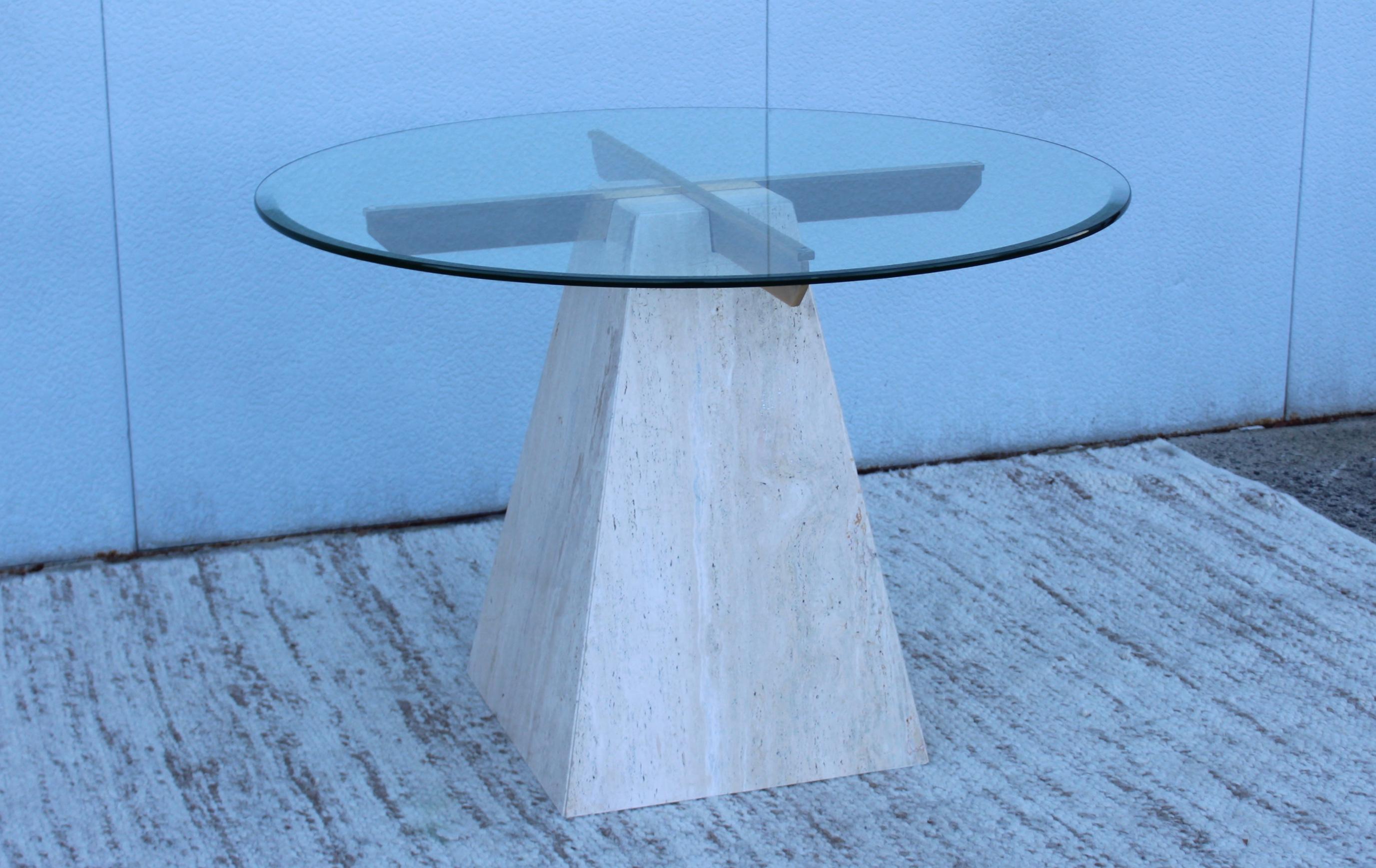 Stunning 1970s modern travertine base with glass top Italian dining table. In vintage original condition with minor wear and patina due to age and use.