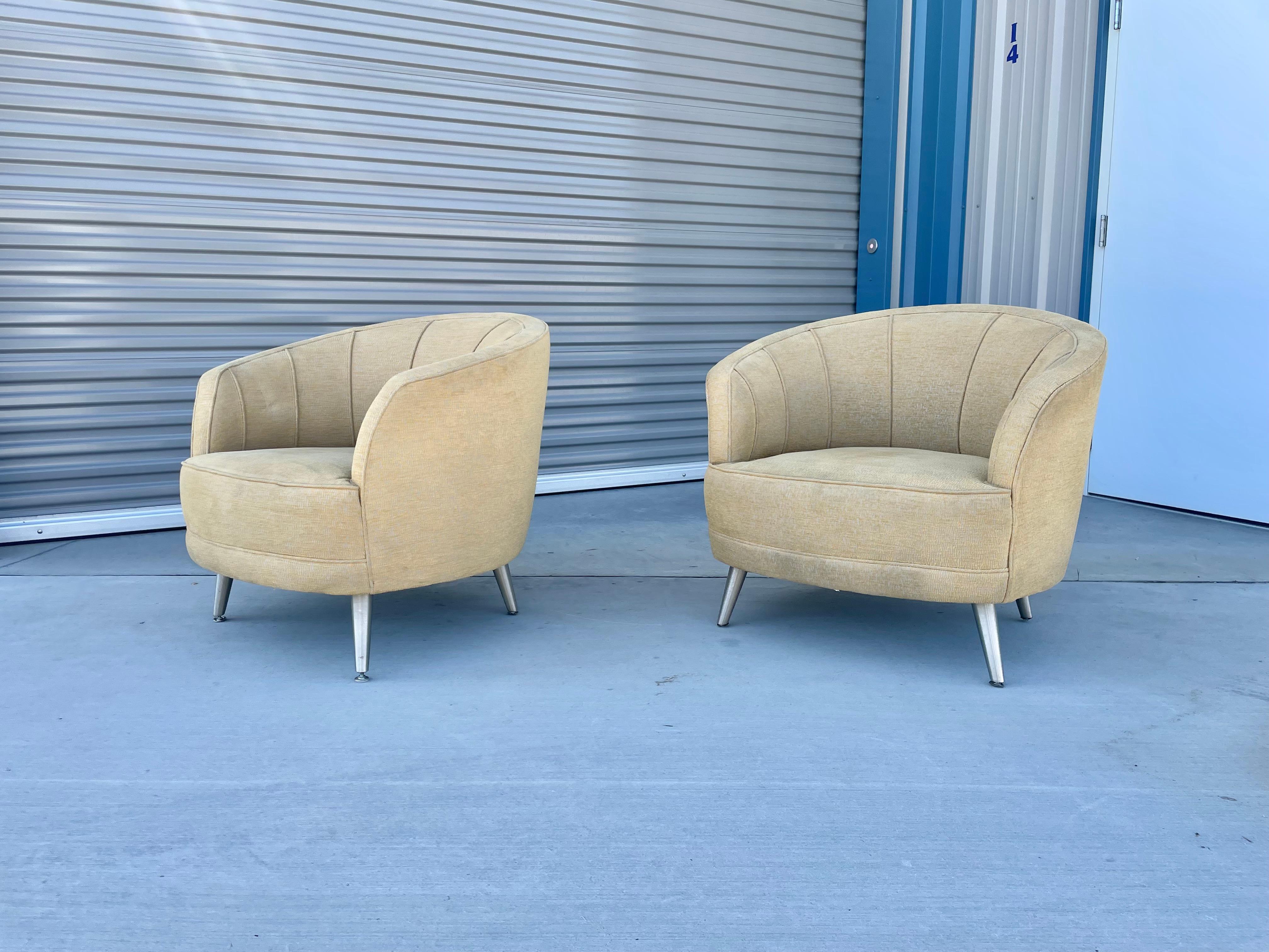 Mid-century modern lounge chairs designed and manufactured in the United States circa 1970s. These beautiful chairs feature a curve clamshell backrest that provides comfort and style. The chair's upholstery does have a bit of age to it but can be