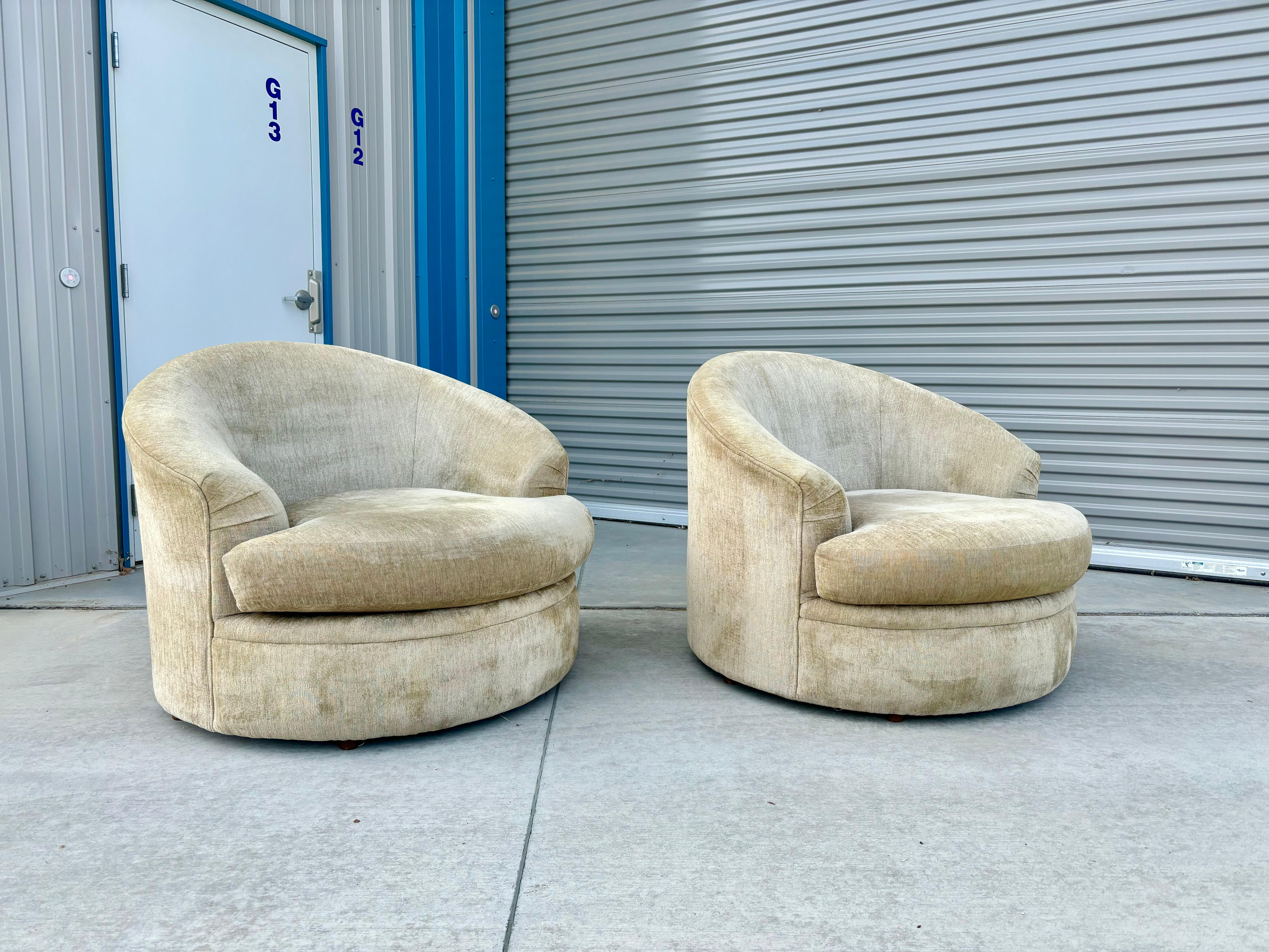 These beautiful mid-century modern lounge chairs was designed and manufactured in the United States circa 1970s. The unique barrel shape of these chairs is perfectly complemented by a curved backrest, providing both style and comfort. The chairs