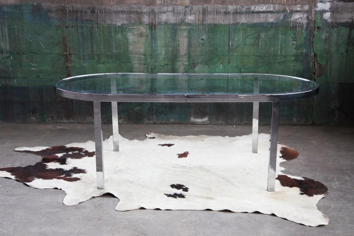 High quality, original, Design Institute of America chrome and glass racetrack dining or conference table in very good condition. Seats up to 6 people comfortably. Clean, Modern & Sculptural lines are shown through this superb Chrome table base with