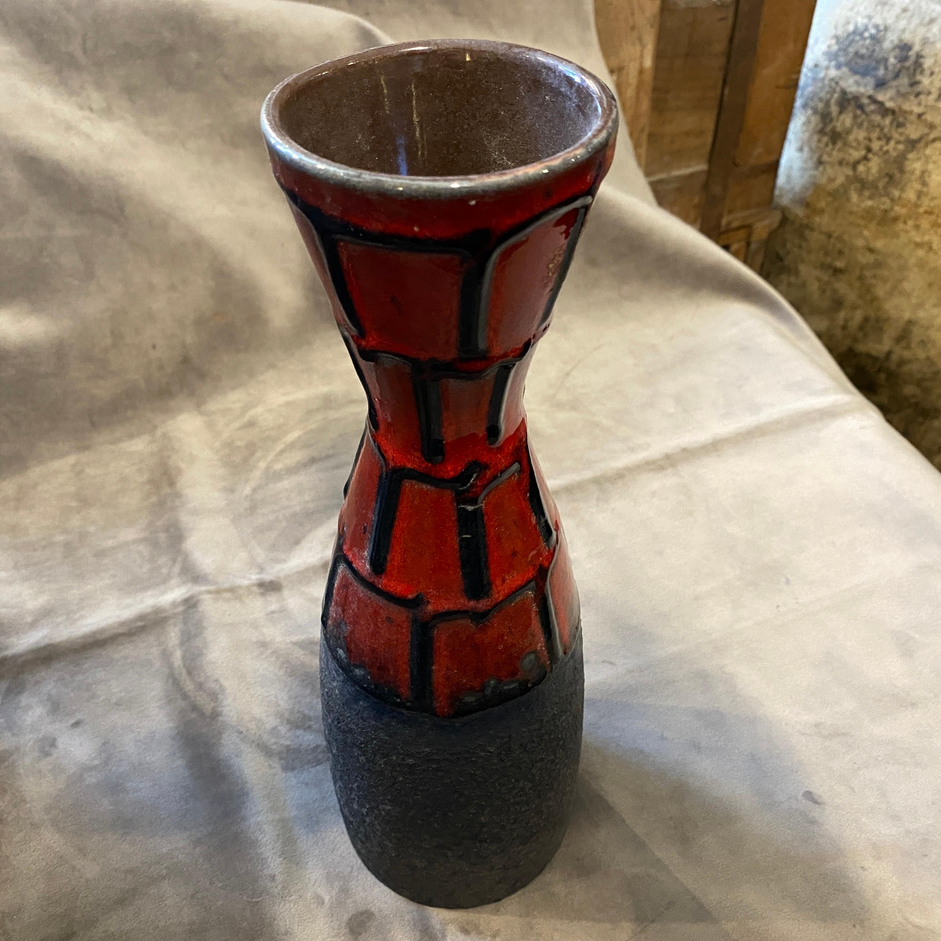 A red and black ceramic vase made in Germany in the Seventies by Roth Keramik. This kind of ceramic has been called Fat Lave KeramiK and it was very popular in Italy and Germany in the Mid-20th century. It's marked West Germany and numbers on the