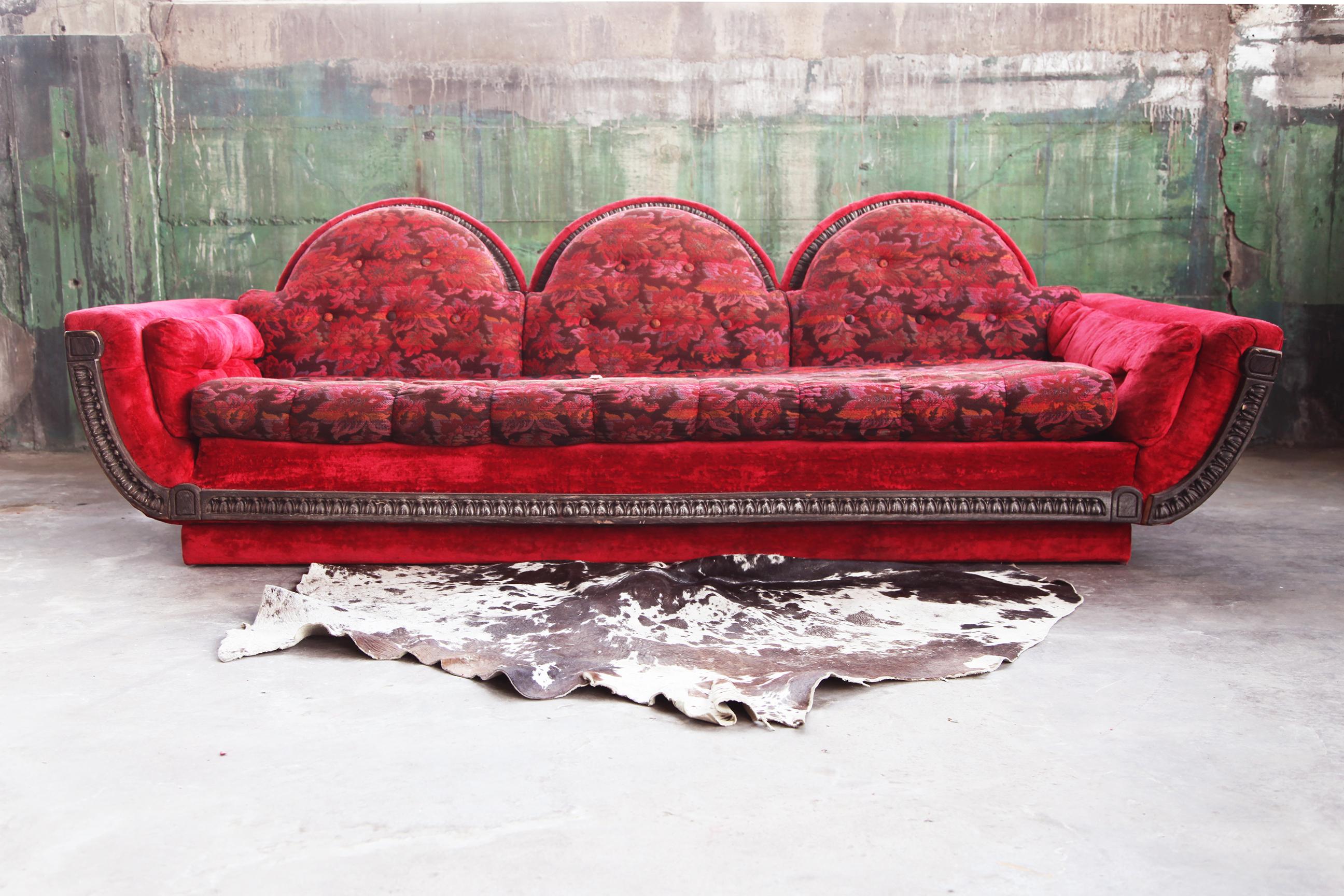 Very exciting and quite rare 1970s three-seater sofa in the manner of Adrian Pearsall for the Strictly Spanish line. The sculptural shape, tufted arms and detailed, carved plinth base and trim are very unique, and the piece makes quite the statement