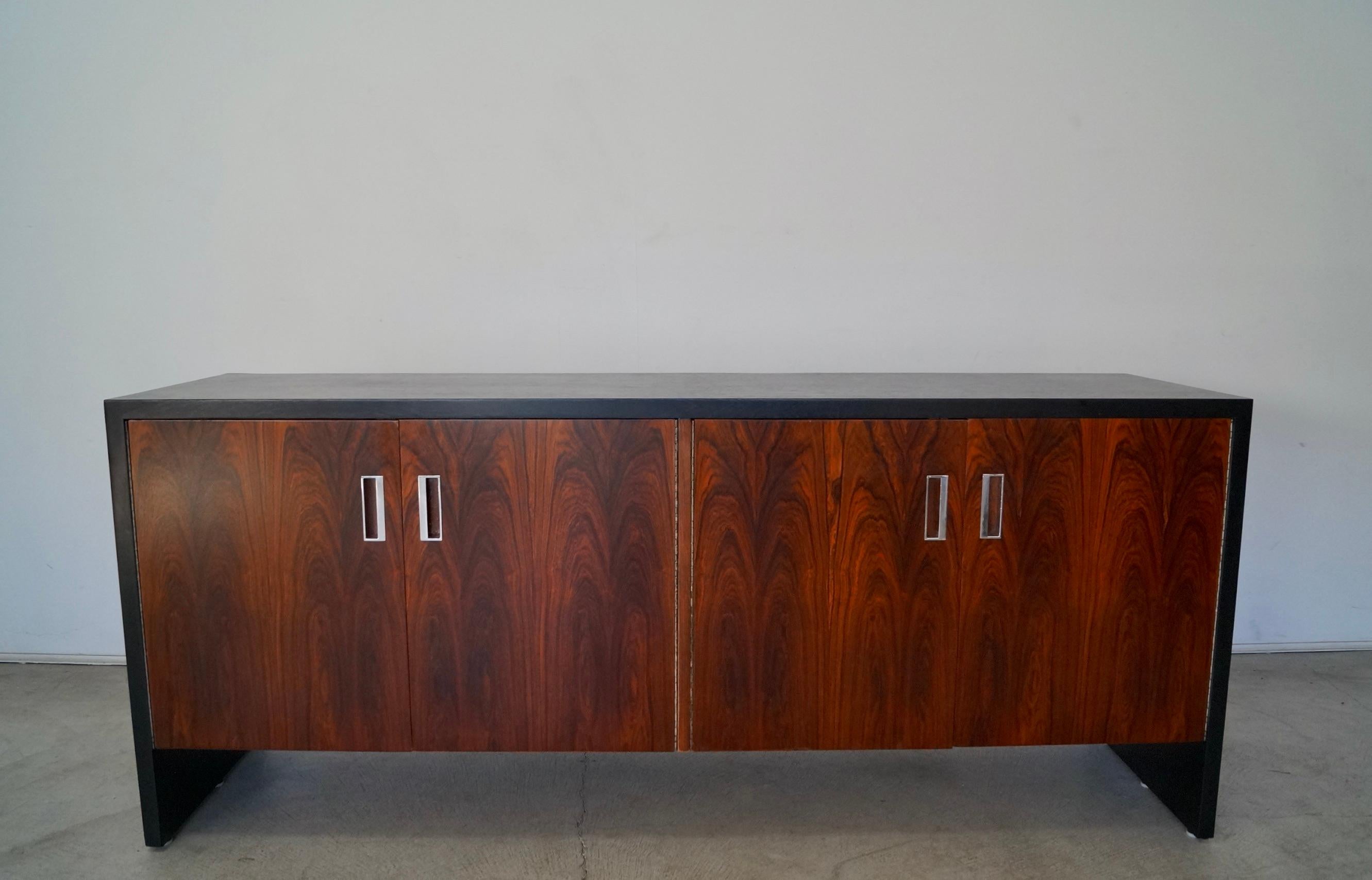 Original Mid-Century Modern sideboard for sale. Designed by Robert Baron for Glenn of California, and has been professionally refinished. It dates back to the 1970's, and has been beautifully restored. It has two cabinet doors in rosewood with