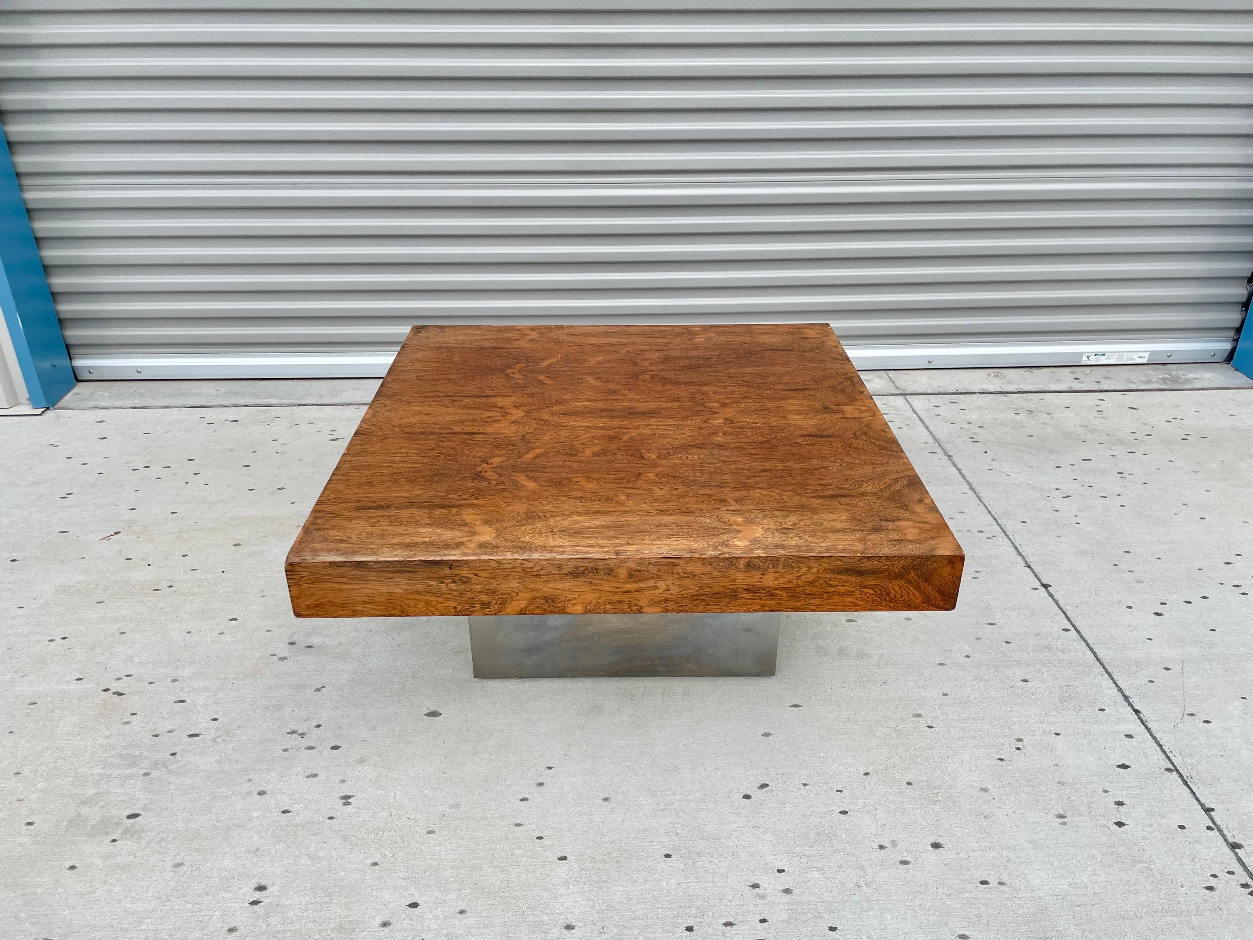 Mid-century modern rosewood & chrome coffee table designed and manufactured in the United States circa 1970s. This stunning coffee table features a rosewood top that sits on top of a chrome base giving it a great distinctive design for their era.