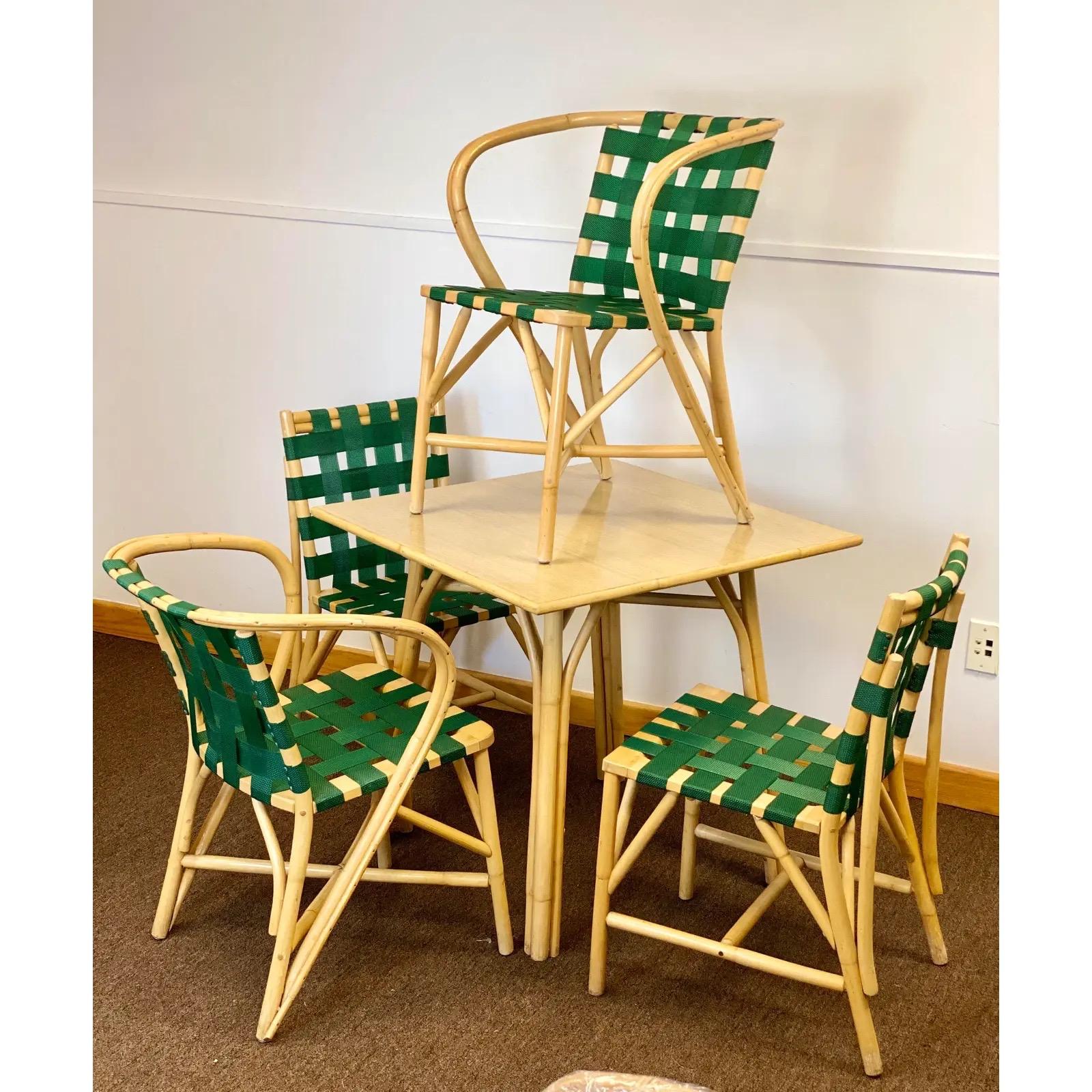 Jens Risom meets McGuire. We are very pleased to offer a Mid-Century, sculptural set of four dining chairs and one dining table, circa the 1970s. The simplicity and artistry of this set radiates from its materials. Strong and durable green straps