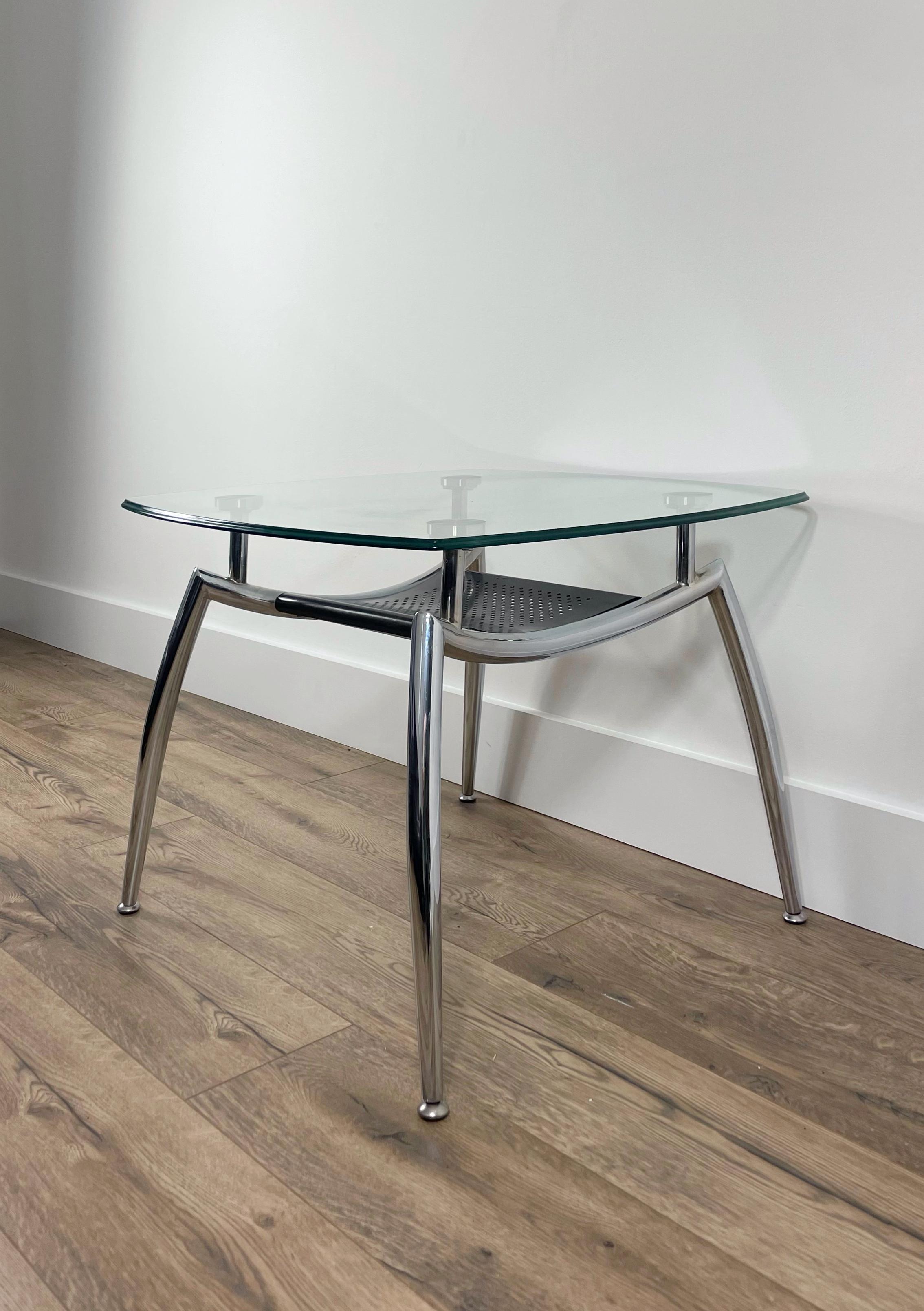 This beautiful and unique coffee table was manufactured in the 70s. The shape of this coffee table is extremely unique and puts a modern twist on this mid century piece. The glass and chrome is very cool and clean looking. This coffee table features