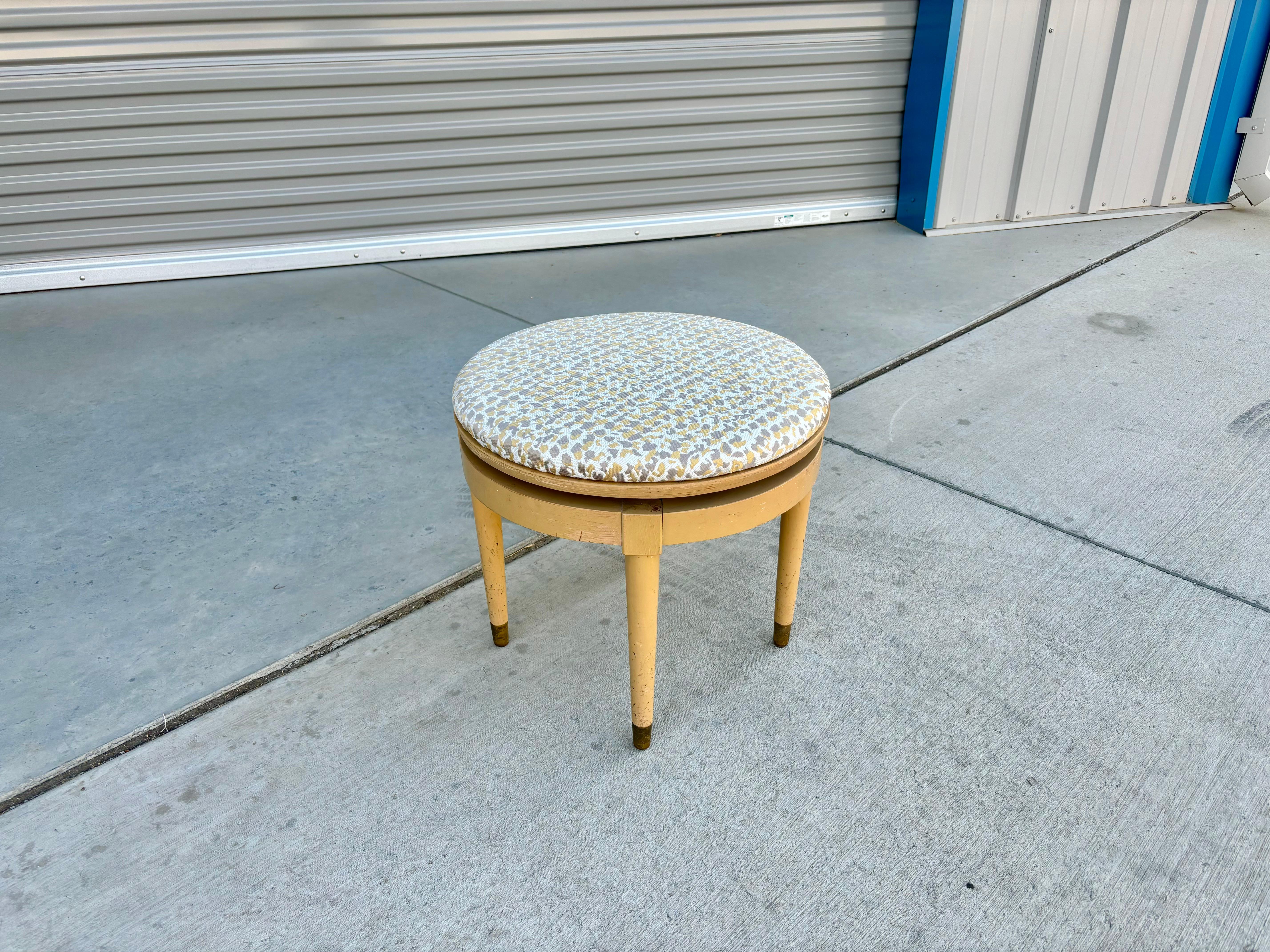 Mid-century modern swivel stool designed and manufactured in the United States circa 1970s. This stool is truly a work of art, with a wooden base allowing you to swivel 360 degrees. The stool has been newly upholstered, giving it an extra modern