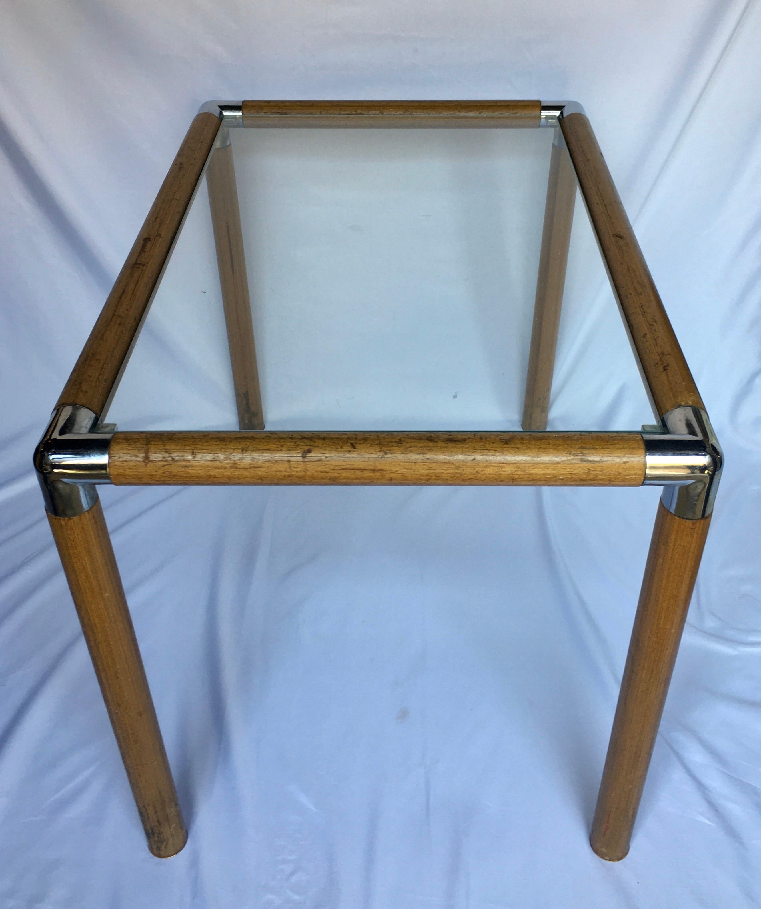 Mid-Century Modern side table featuring a tubular wood frame with chrome corner caps. This rectangular end table has a removable clear glass top.