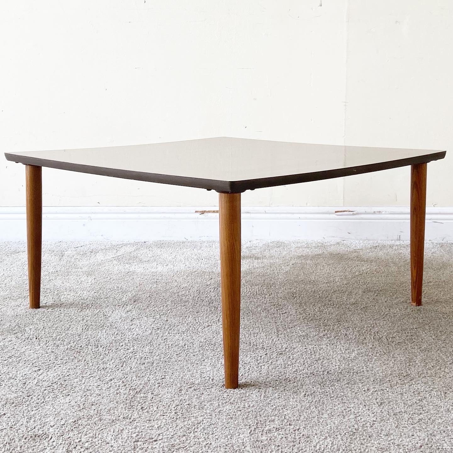 Incredible mid century modern wood coffee table. Features a smooth wood grain laminate top.