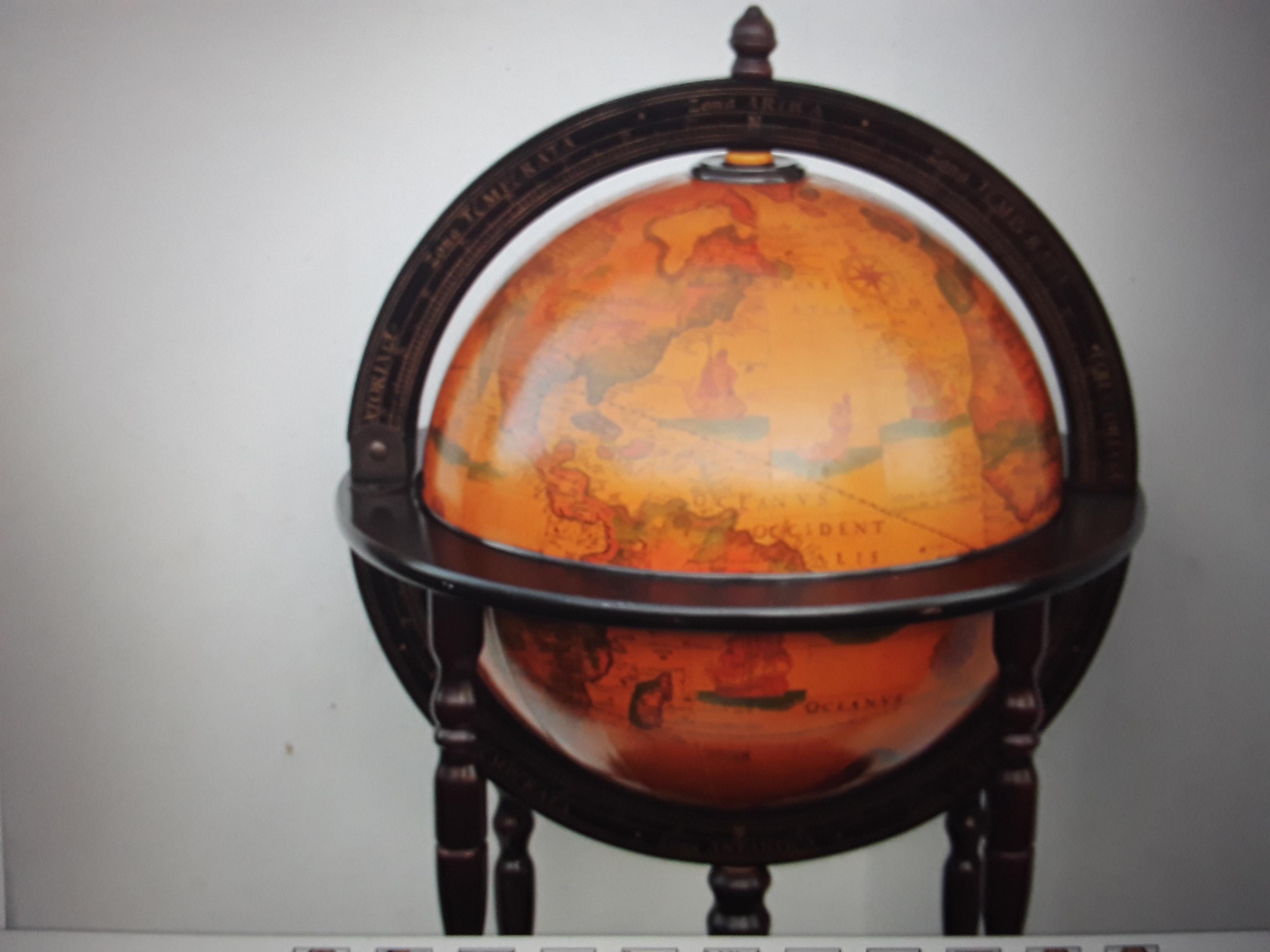 1970's Mid Century Modern World Globe Dry Bar. Top of globe opens to reveal interior storage. Beautifully carved wood base. Please look at pictures closely as they are part of the description.
