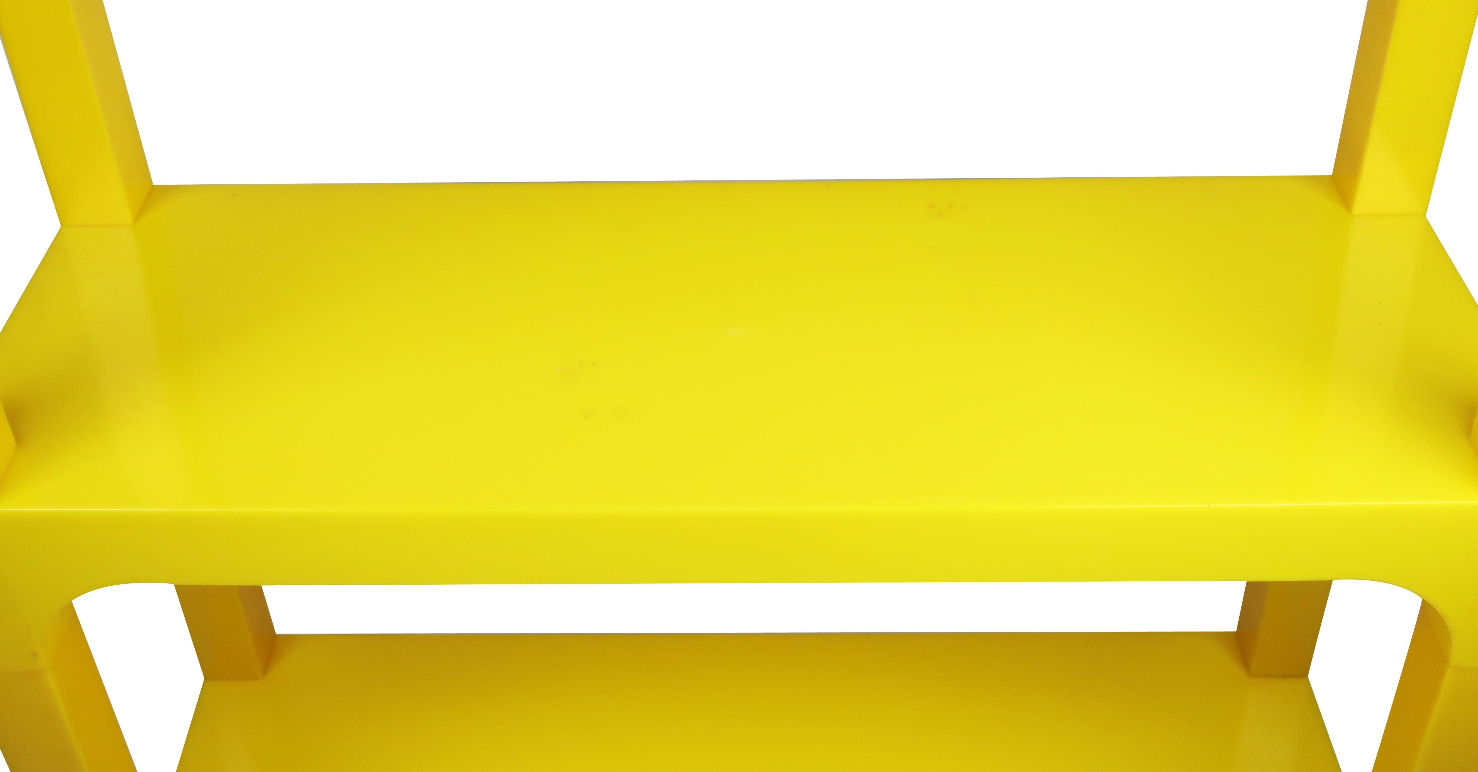 A bright and sunny vintage yellow plastic shelving system in the style of Kartell and the Umbo shelving system that is circa 1970s as can be! It is modular and is useful as a wall unit, bookshelf, or separated as low side tables.

In excellent