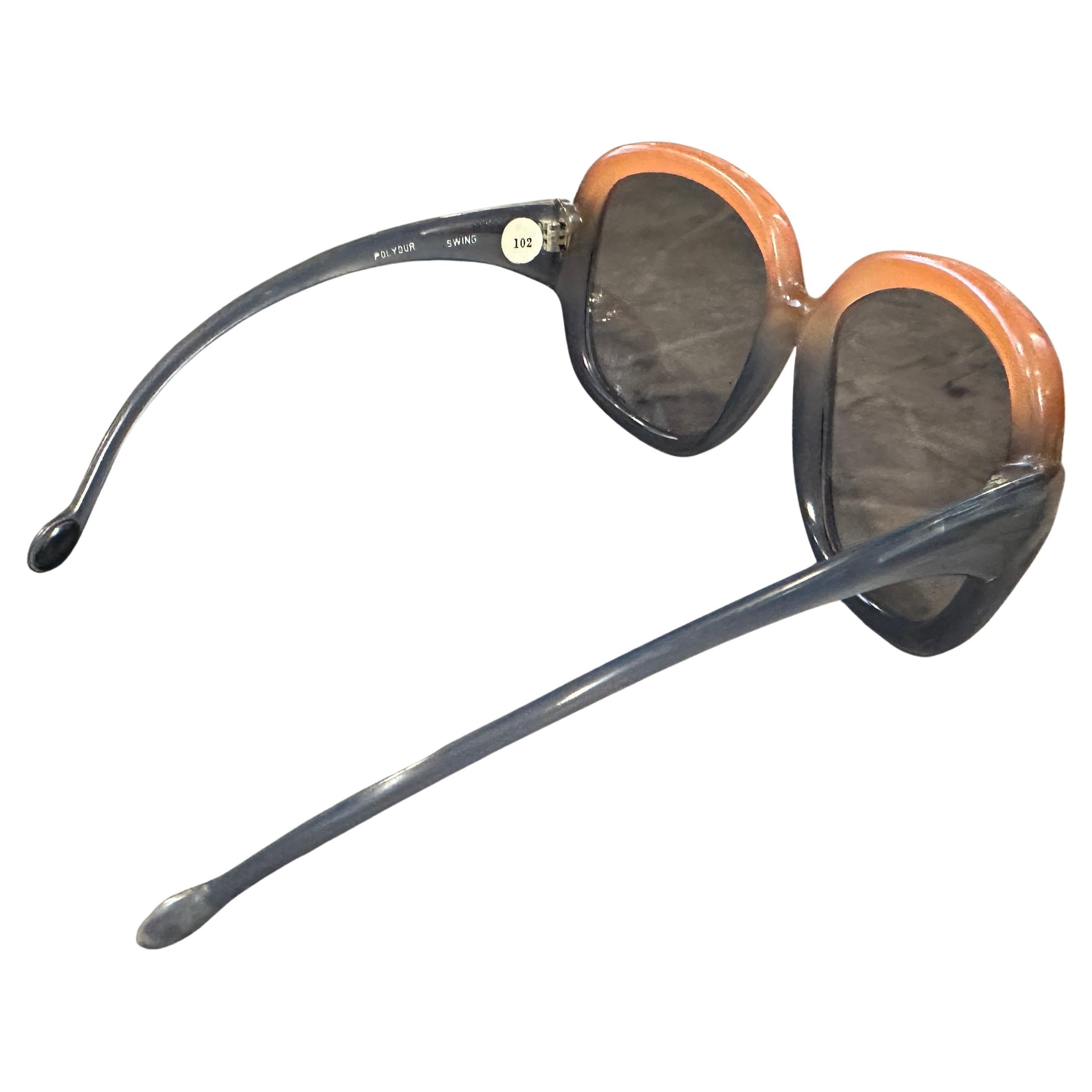 1970s Mid-Century Modern Oversized Sunglasses by Lozza  Orange and Blue Gradient
Step into the vibrant style of the 1970s with these captivating oversized sunglasses by Lozza, a renowned Italian eyewear brand known for its quality and distinctive