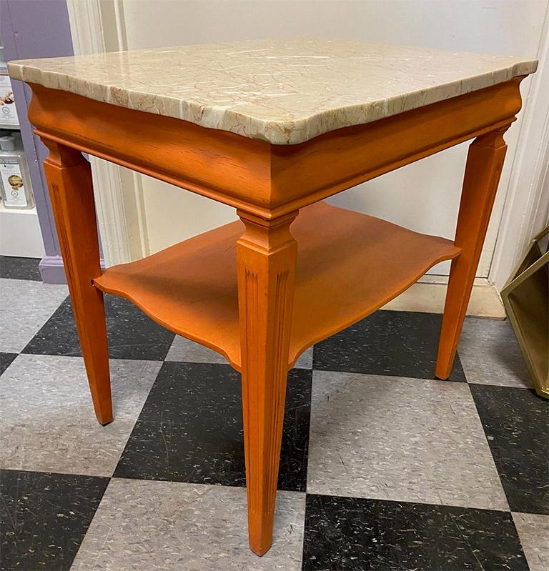 Fun midcentury marble top end-table recently painted in Barcelona orange with a dark wax finish. The top is the original marble and is in shades of neutral with veining that coordinated with the paint finish. The marble is removable. The stationary