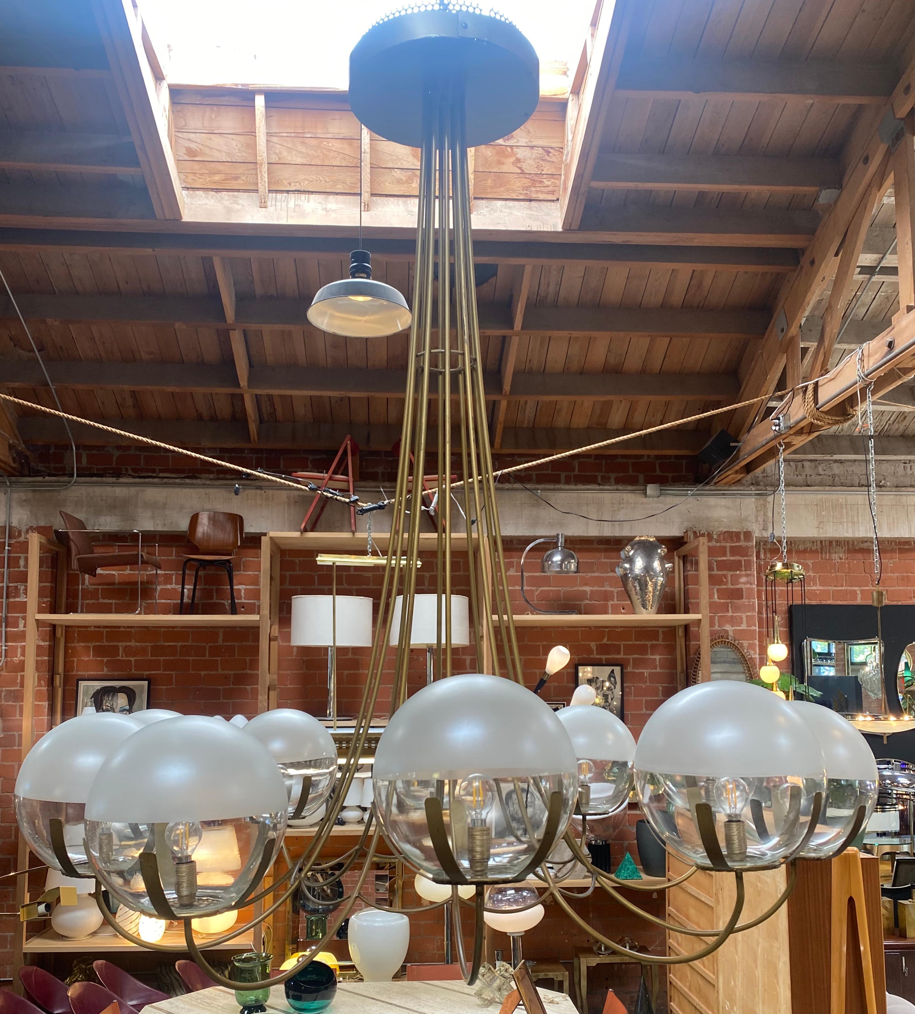 Beautiful oversize Italian fully brass chandelier composed form 10 spheres , the chandelier was made in 1970 in Italy present minor uses and vintage conditions. Fully functional this chandelier is ready to complete a mid century style home. A piece