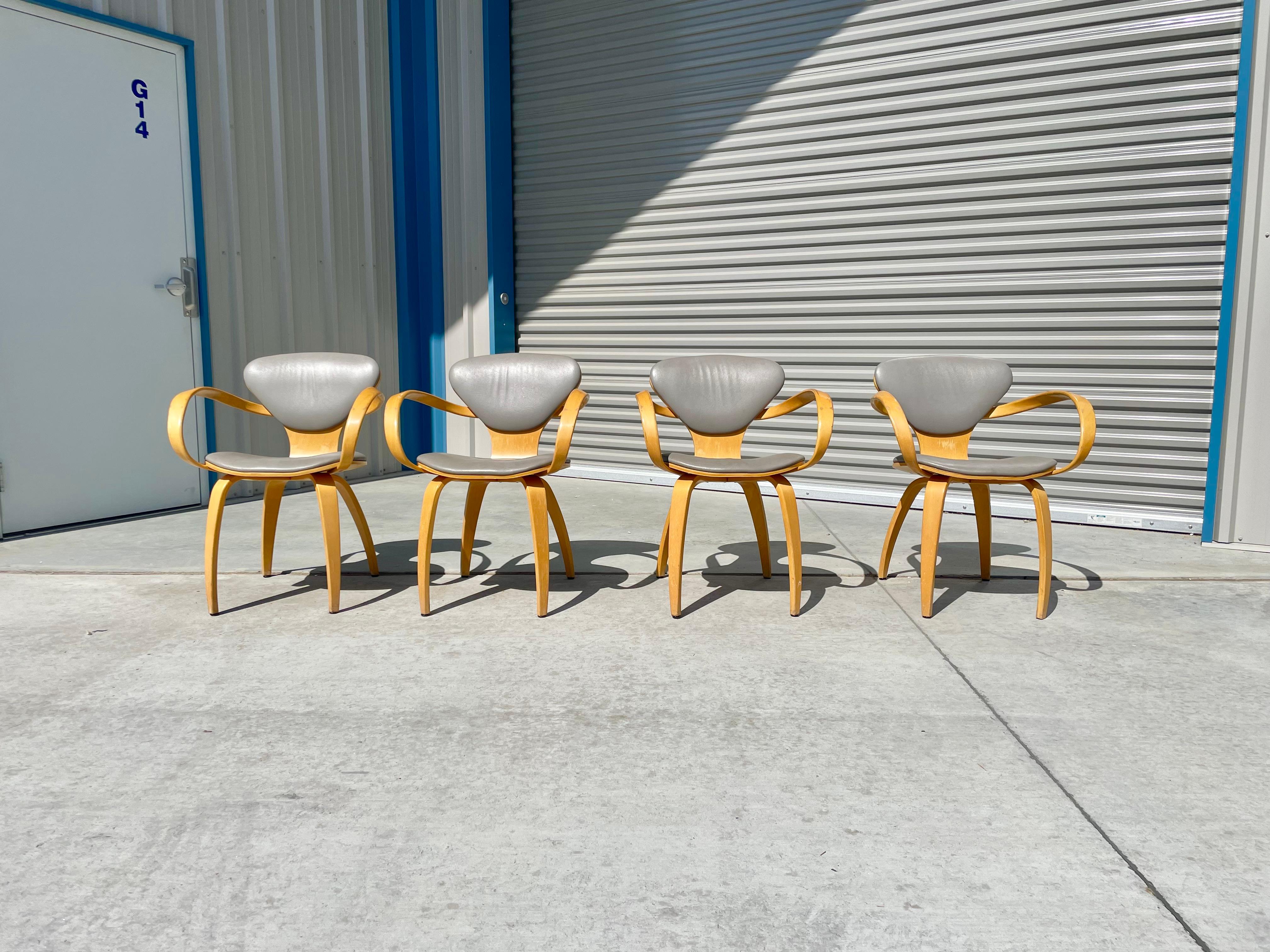 Mid-century pretzel armchairs designed by Norman Cherner and manufactured by Plycraft in the United States circa 1970s. These Pretzel armchairs are made from molded plywood, formed by layering thin sheets of wood and bending them into shape. The