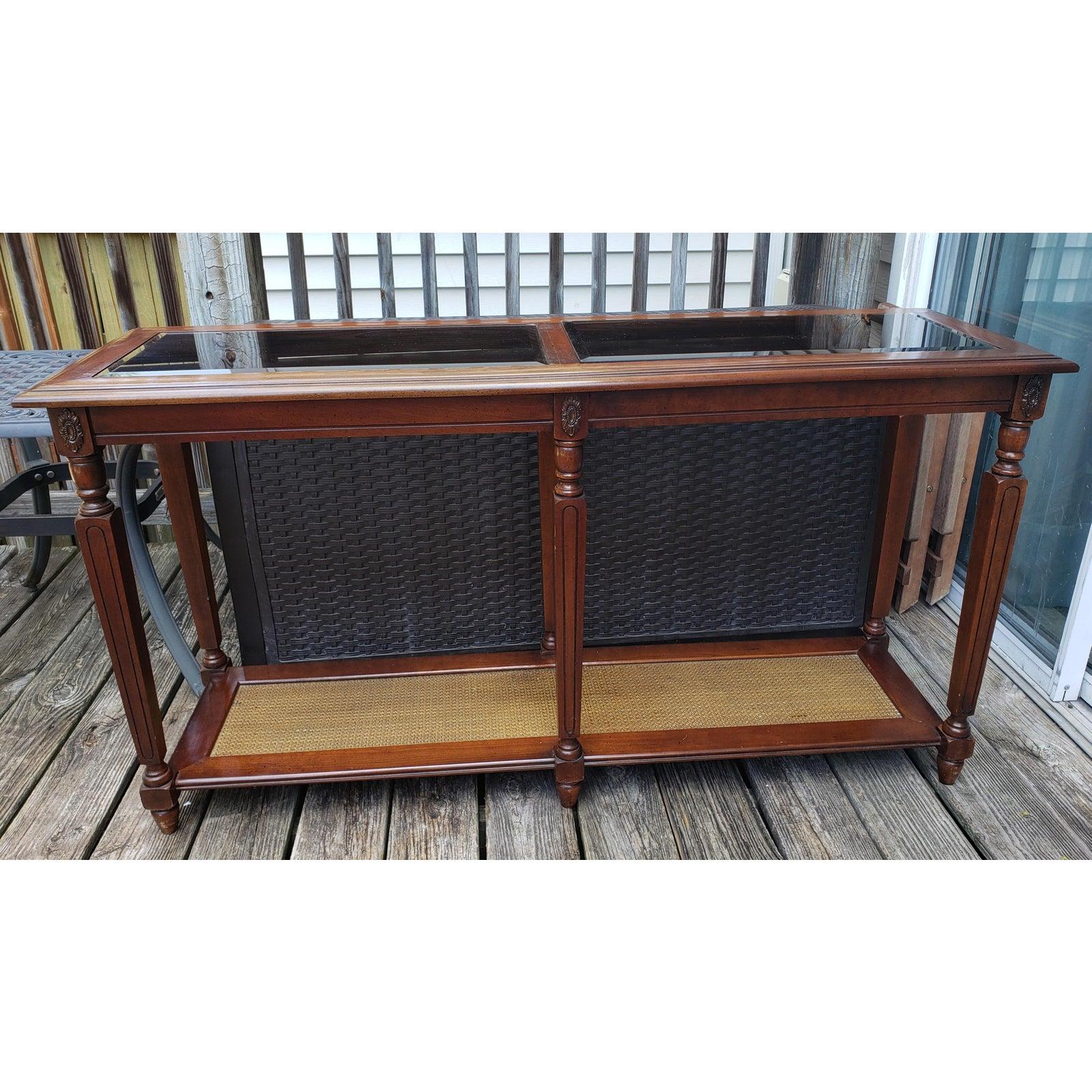1970s walnut two tier glass top console table with faux caning shelf. Two removable, smoked, beveled glass top inserts. First tier faux caning.
This stunning walnut Mid-century modern two-tier console table in the style of Severin Hansen can be
