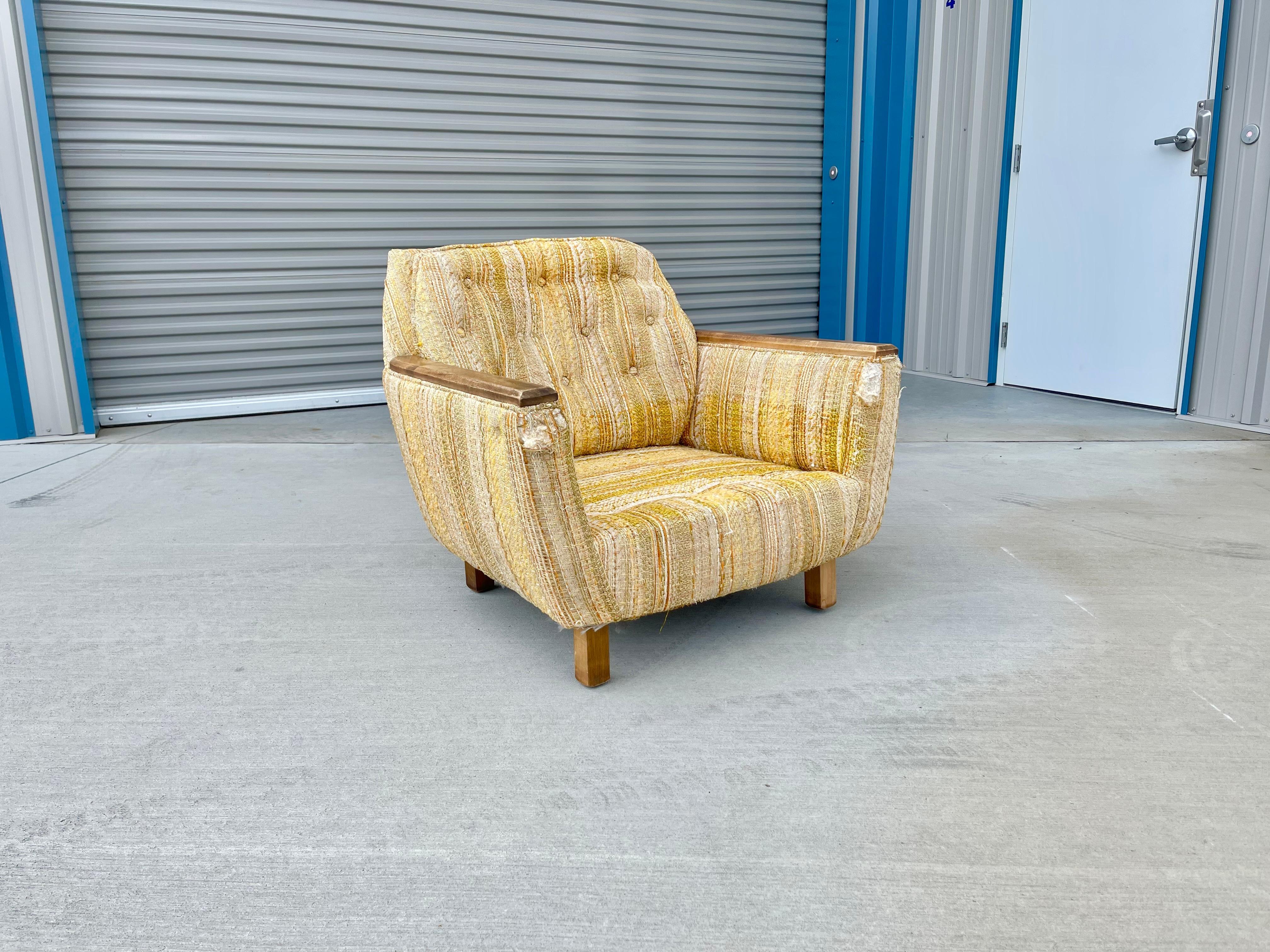 Mid-century walnut chair designed and manufactured in the United States circa 1970s. This fantastic chair features its original upholstery with a walnut frame armrest giving it a unique style to them. The chair needs to be reupholstered, but this is