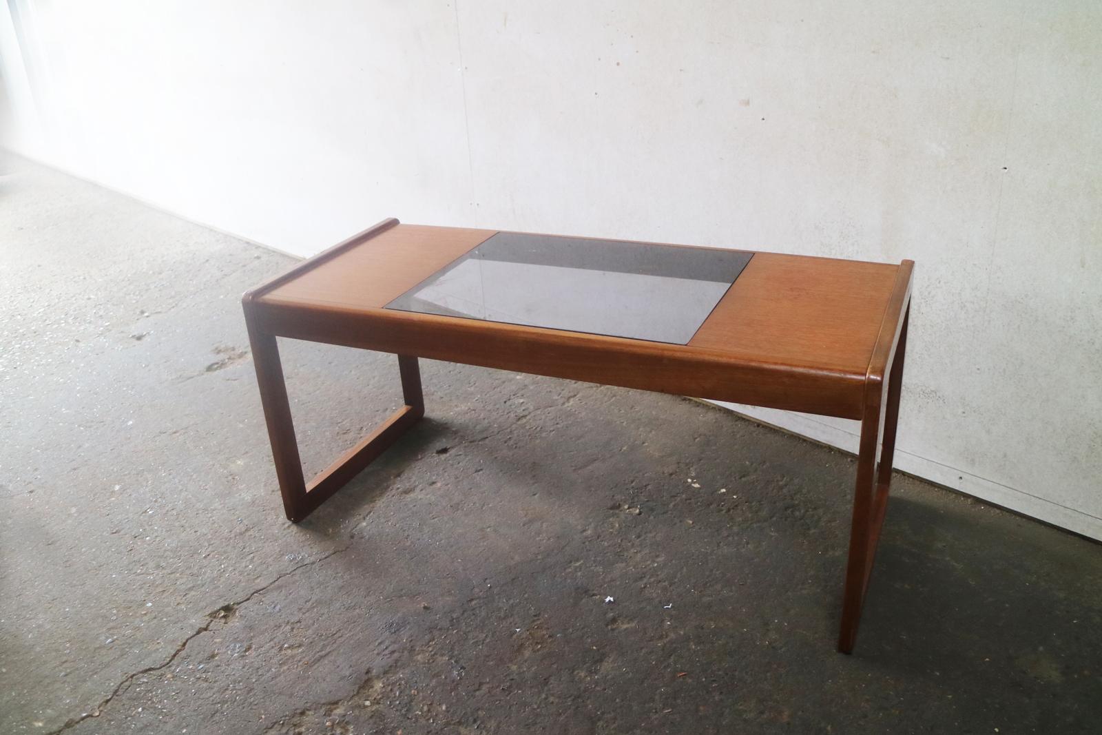 Stylish coffee table from G plan. Solid teak frame with a smoked glass inset.

Country of origin: UK
Date of manufacture: 1970s 
Material: teak and smoked glass
Size : width 95cm x height 43cm x depth 42cm
Condition: Very good vintage