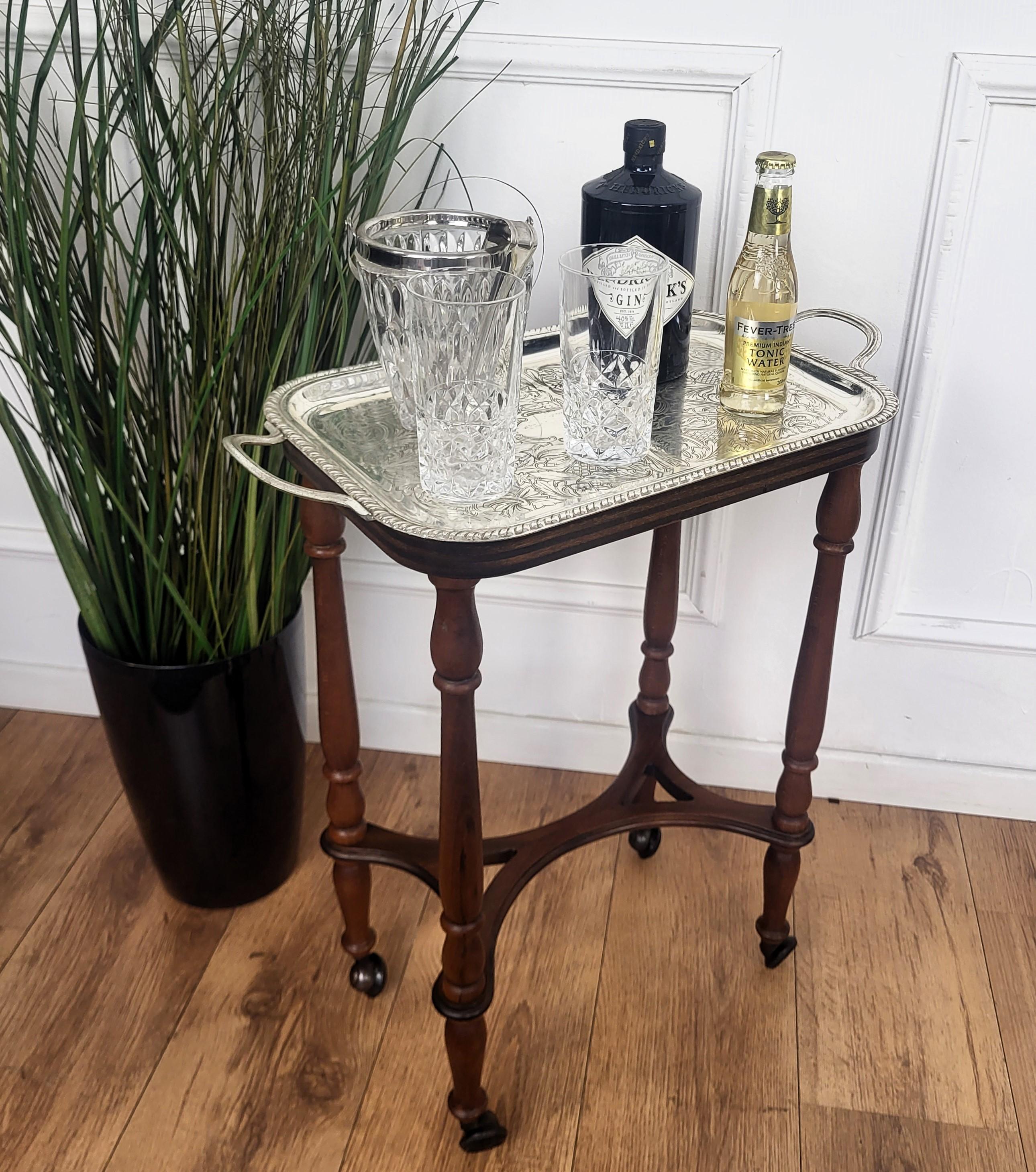 Unique and very elegant Italian Neoclassical MidCentury small serving cart side table with top metal removable tray highlighted by the great wooden structure design and overall shape completed by the details of the original vintage wheels. 