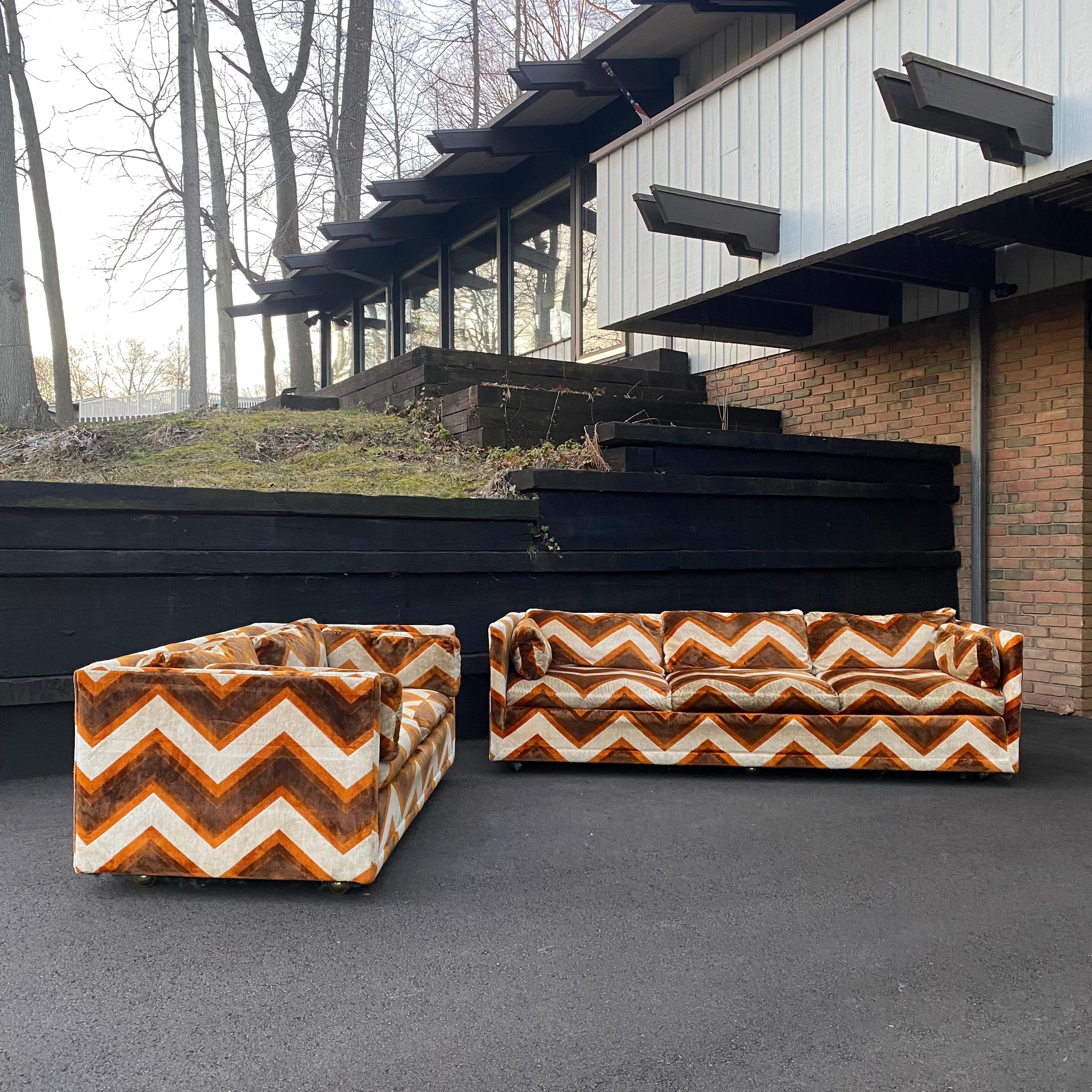 This is an incredibly wild and fun pair of all original white, orange and brown sofas on casters by Bernhardt Flair, circa 1970s. Milo Baughman for Thayer Coggin style.

Condition: This set shows some discoloration to some cushions. There's a mark