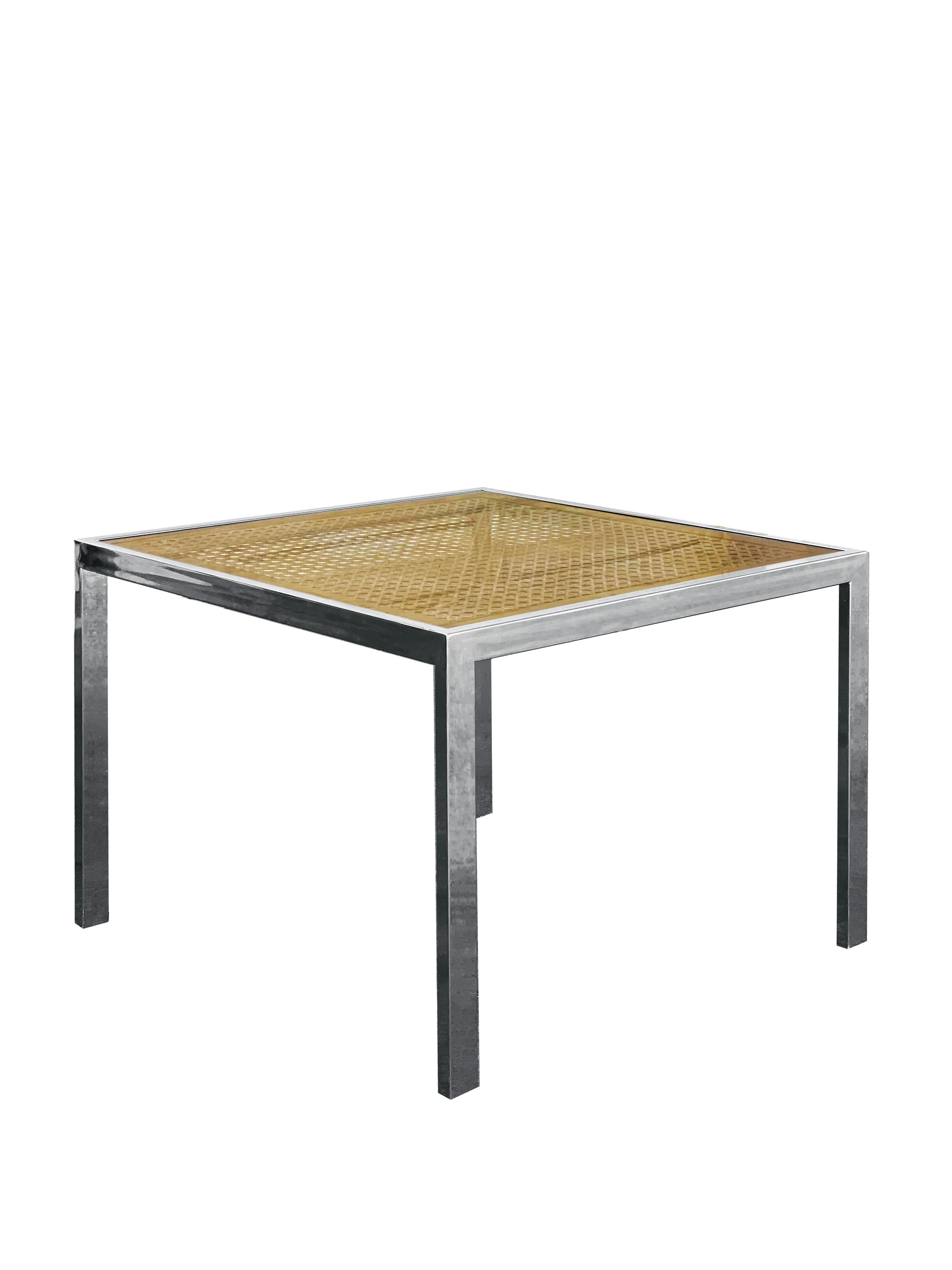 This is a gorgeous 1970s Milo Baughman dining table (or games table!) featuring an inlay of caning with a glass surface on top of a polished chrome framework. The glass top is removable if needed. Overall table is in stunning condition, with