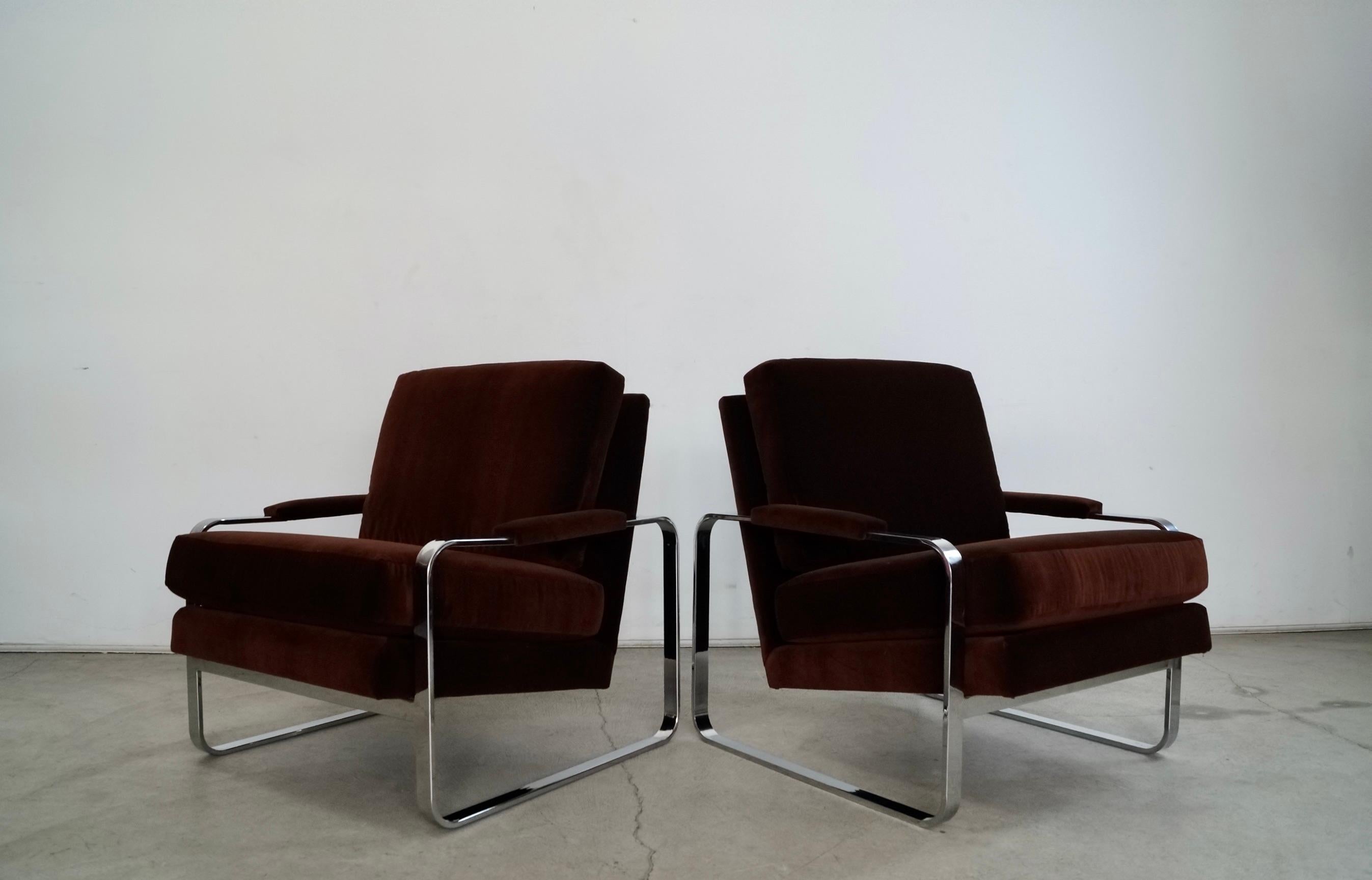 Pair of vintage Midcentury Modern lounge chairs for sale. Designed by Milo Baughman in the early 1970's, and have a flat rounded chrome frame. They have been reupholstered in w deep brown velvet made of cotton, and have come out beautifully with