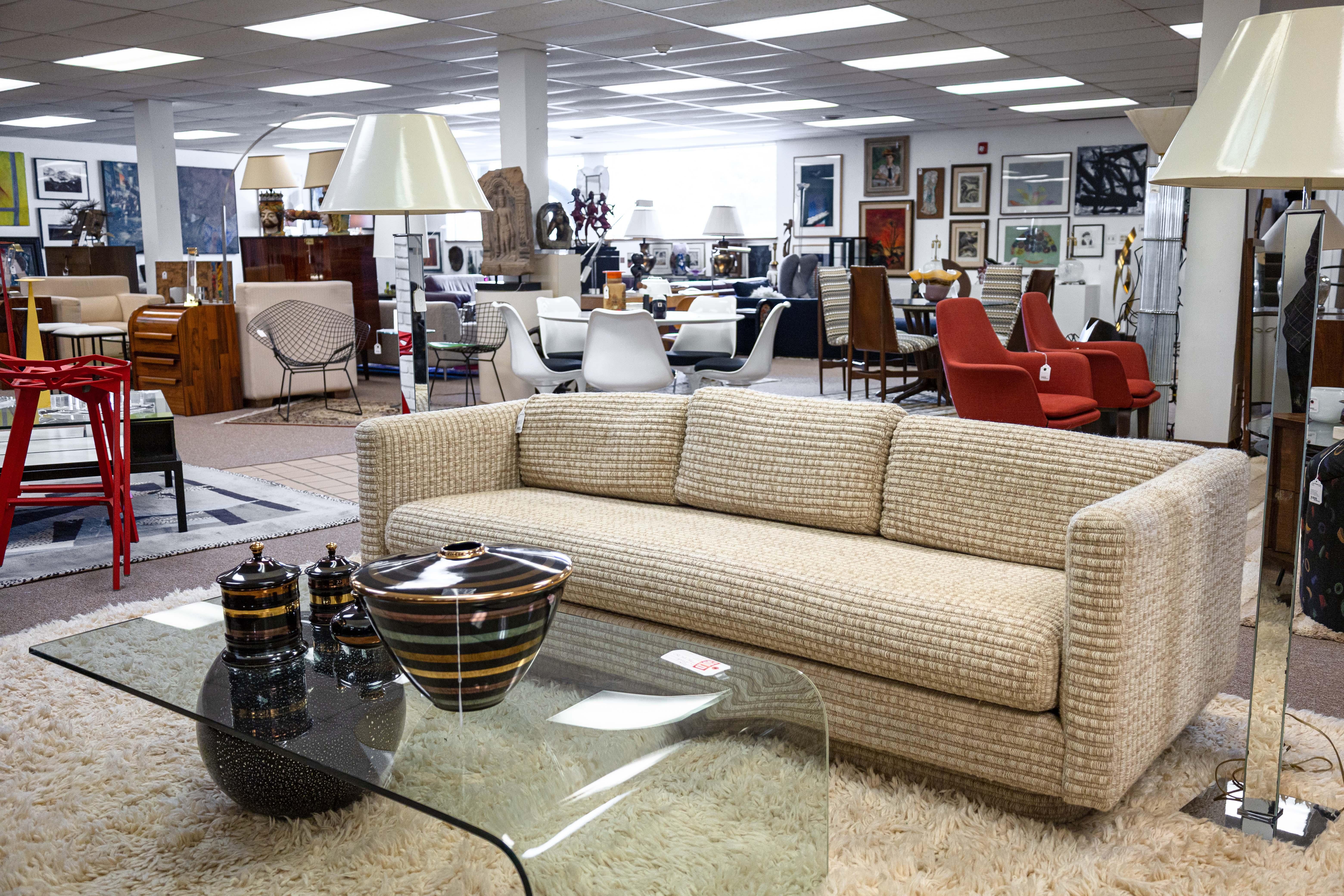 A Milo Baughman for Forecast Furniture plinth base loveseat sofa. This gorgeous sofa features a very 70s design. This sofa has a very iconic Milo Baughman plinth base design that curves around the underside of the piece, perfectly contrasting the