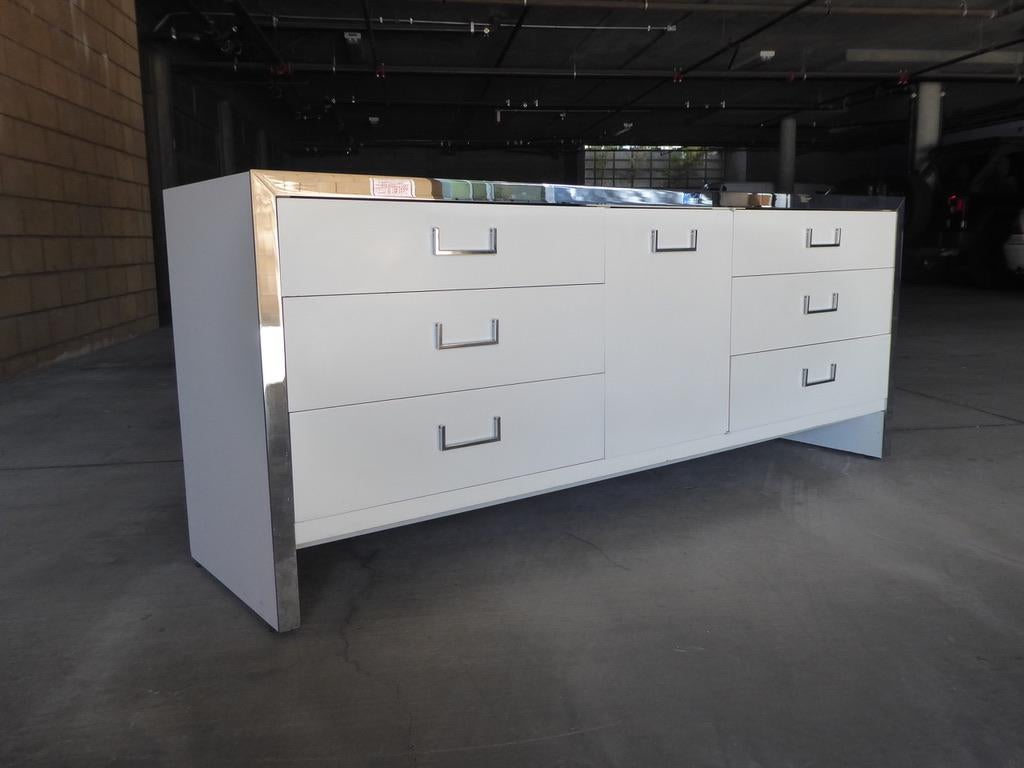 A 1970s credenza by Milo Baughman for John Stuart. White lacquer finish with chrome-plated metal accents.