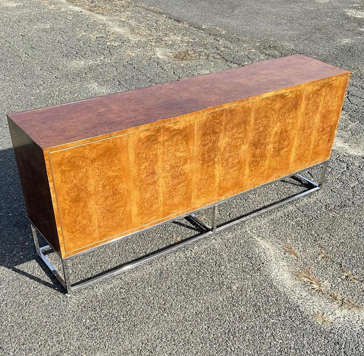 Extremely well cared for in its original factory finish. 

Cabinet is finished with Burl veneer on all sides, chrome is in perfect condition. No pitting or rust. 

No label present. Two adjustable shelves, one on each side.