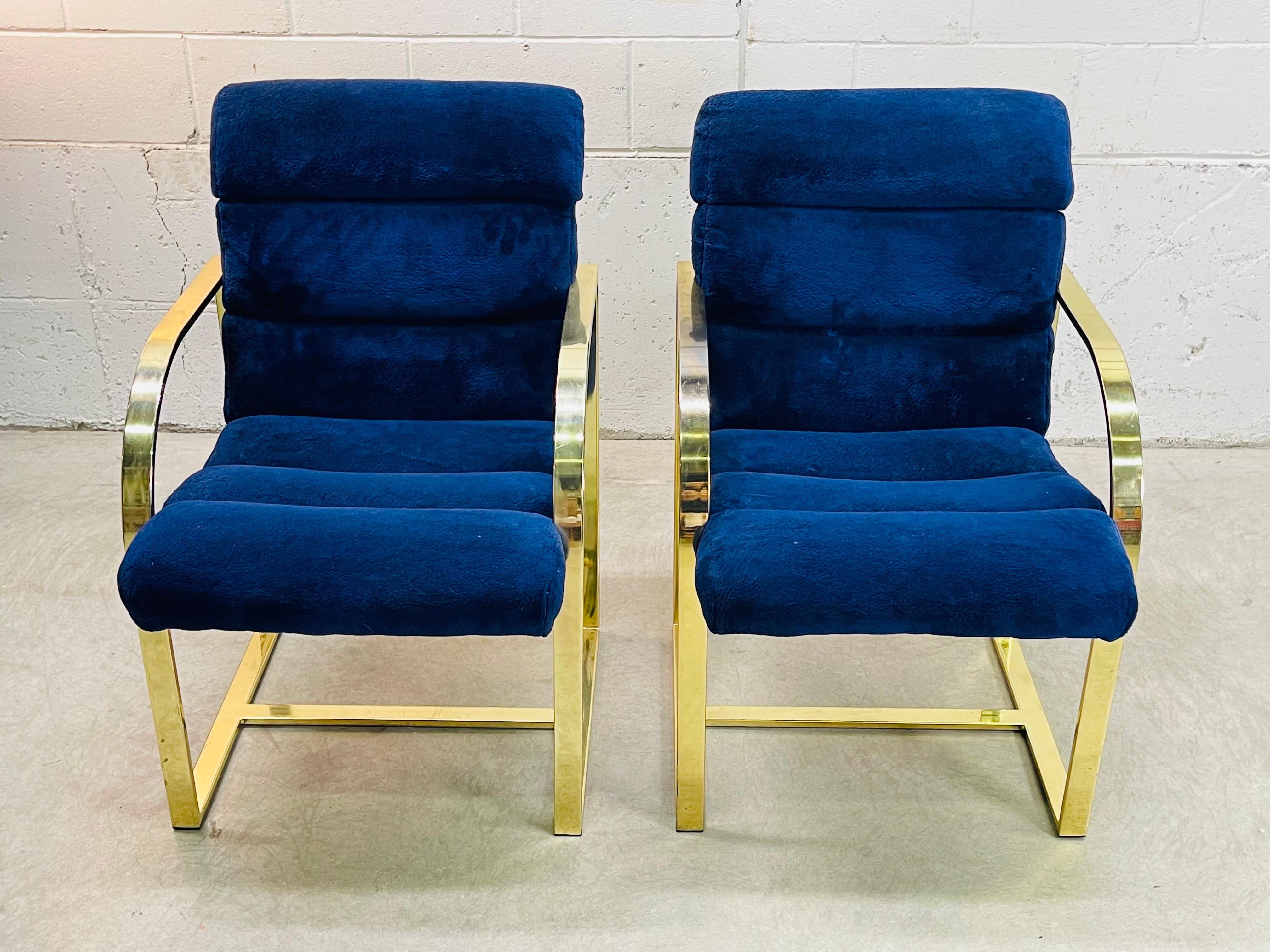 Vintage 1970s pair of flat bar dining chairs designed by Milo Baughman for Thayer Coggin. The chairs are in very good original condition in gold metal with royal blue fabric. Fabric is in very good condition with no stains or rips. These chairs are