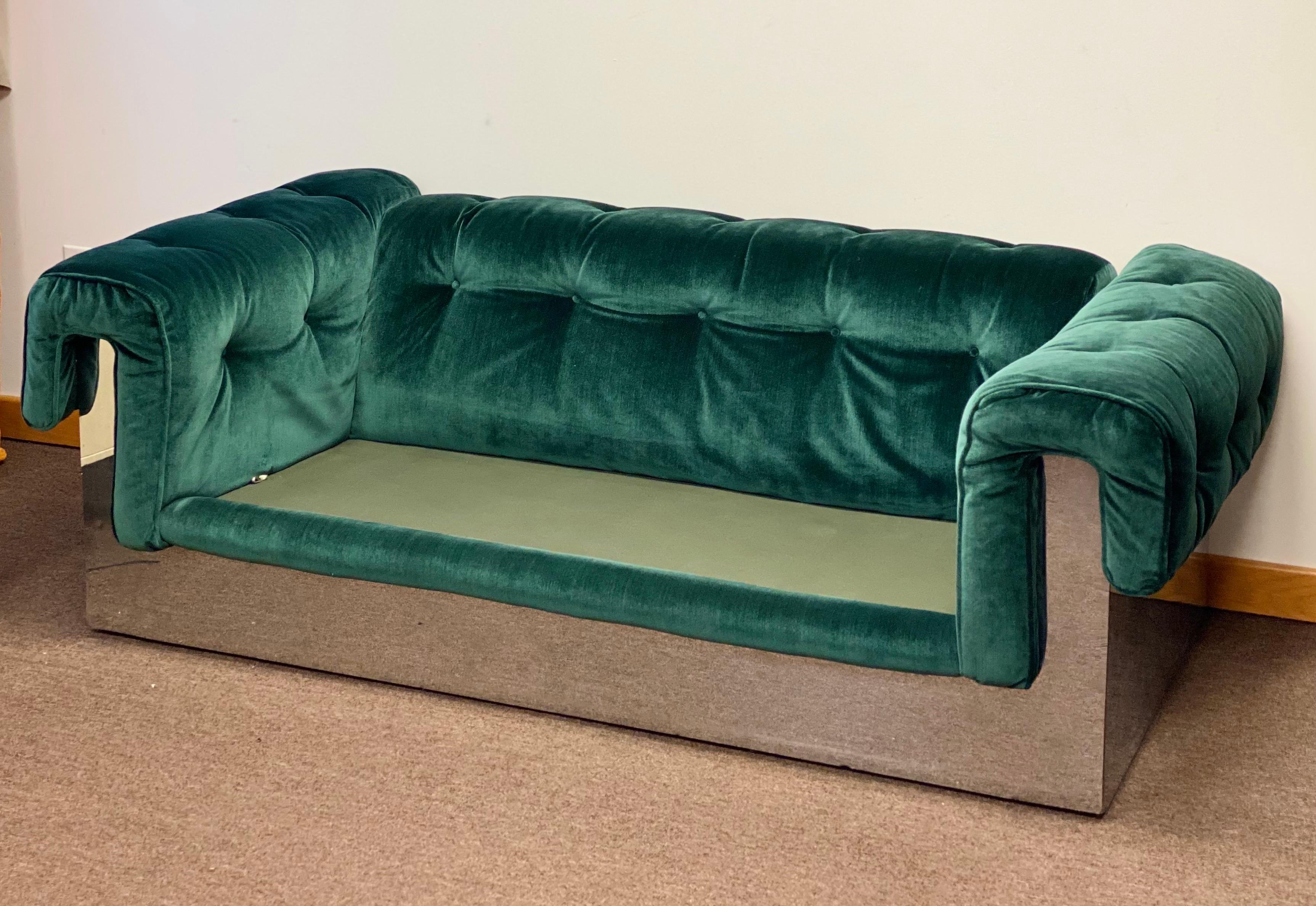 We are very pleased to offer a statement piece by modern furniture designer Milo Baughman for Thayer Coggin, circa the 1970s. A reinvented; forward-thinking chesterfield stretches out on a modern frame wrapped in a rich, emerald green velvet fabric.