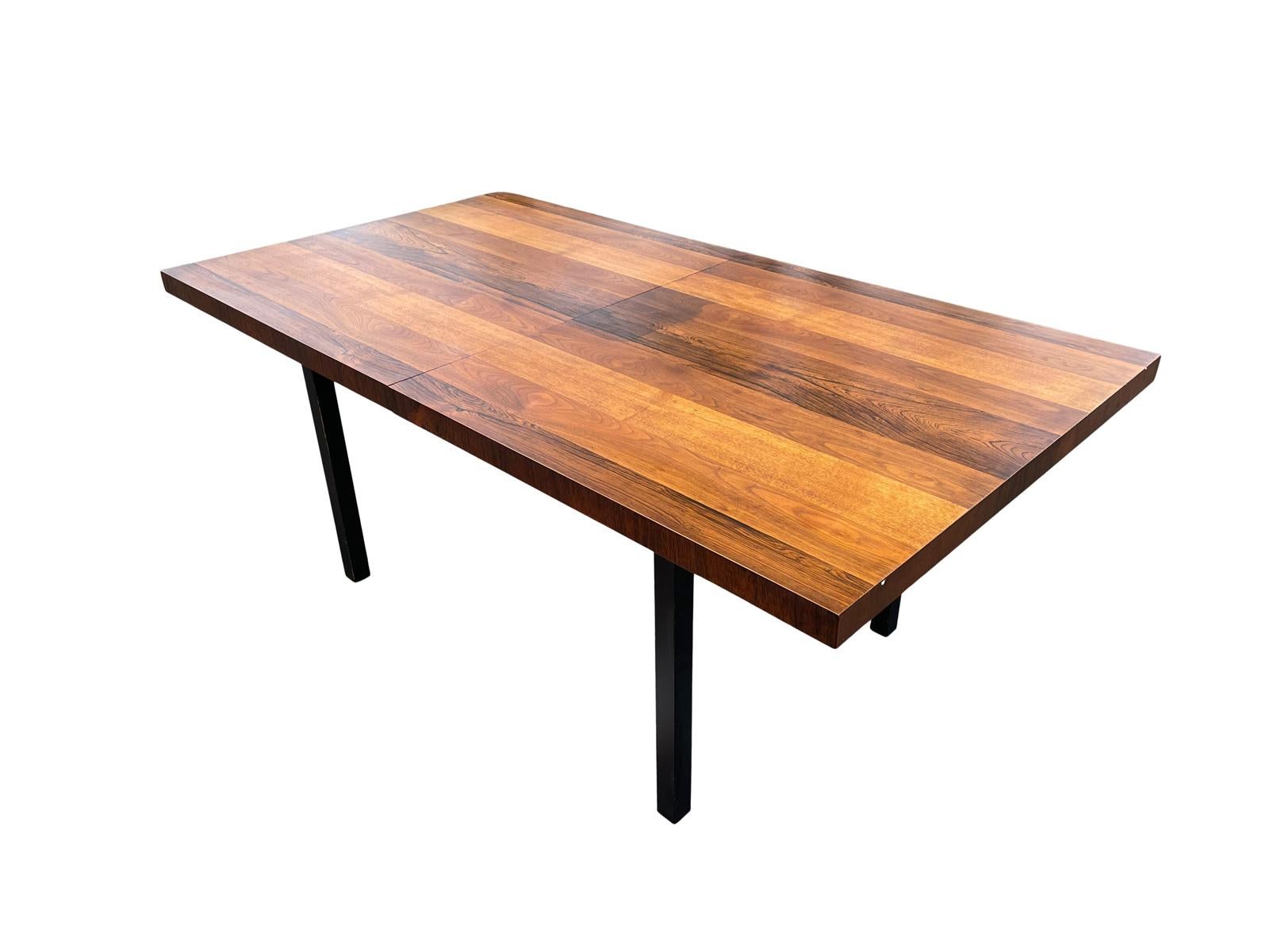 A very well crafted dining table with multi planked woods to the top giving it a sophisticated tailored feel. Using walnut, Brazilian rosewood and mahogany and having a satin black base makes this table seem like it's floating. The best part is that