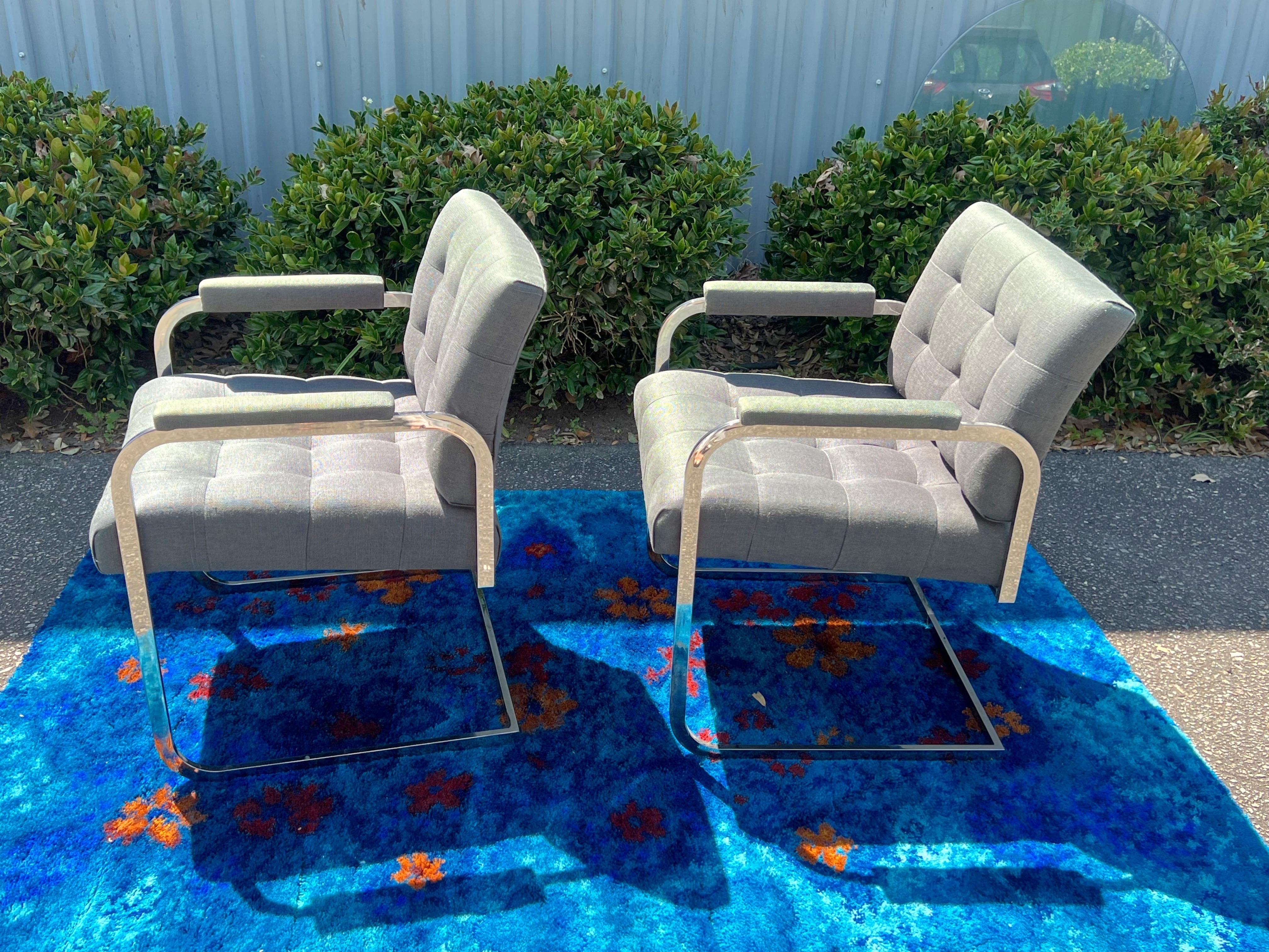 Modern Chrome & Blue Grey Fabric Thin Line Armchair Milo Baughman for Thayer Coggin. They are comprised of fantastic square chrome tube frames and are wearing their original lovely blue gray fabric with button detail on the seat and back cushions
