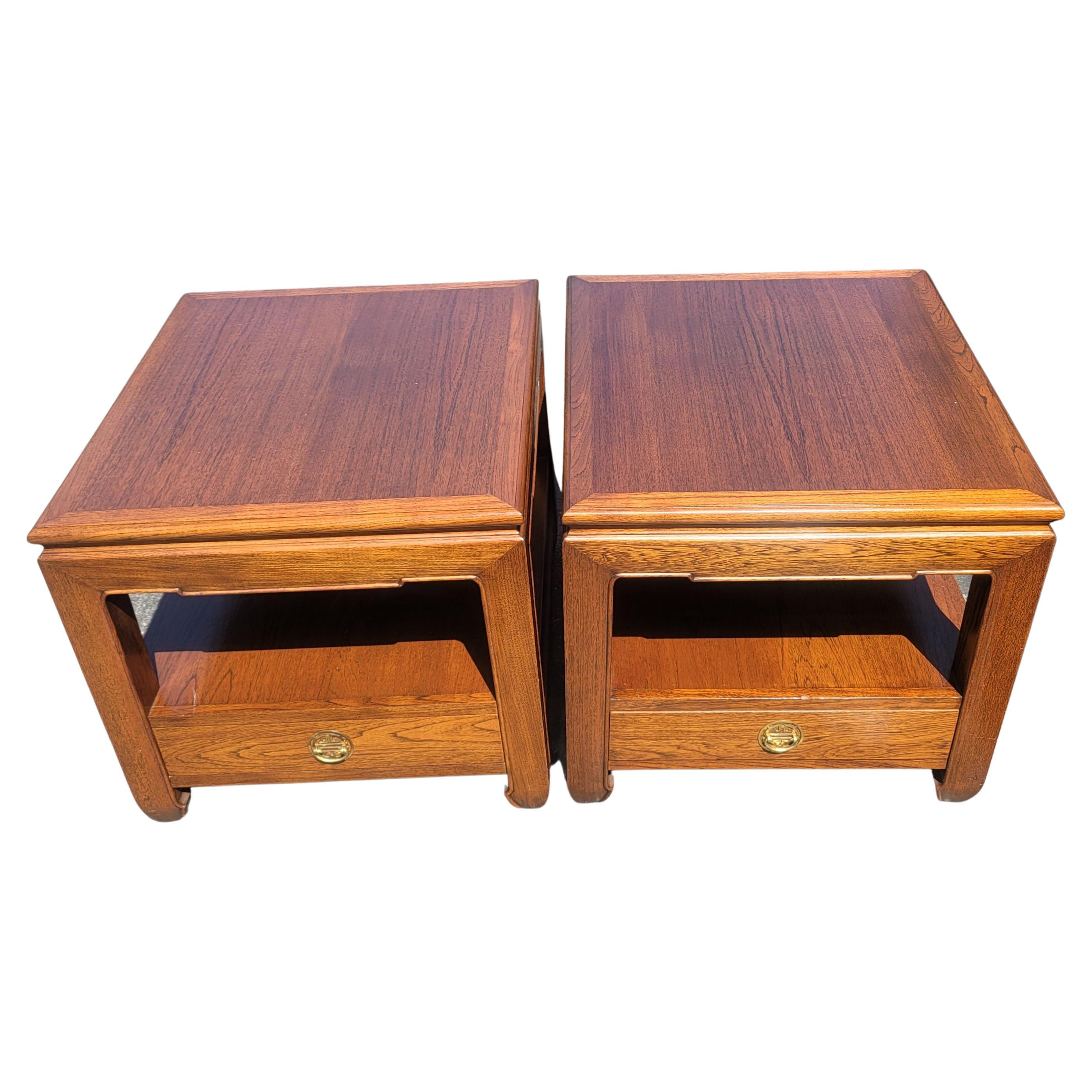 A pair of 1970s Ming style one drawer side tables with protective glass tops in very good vintage condition. 100% All real hard wood. Rock solid pieces. Protective Smoke glass tops.