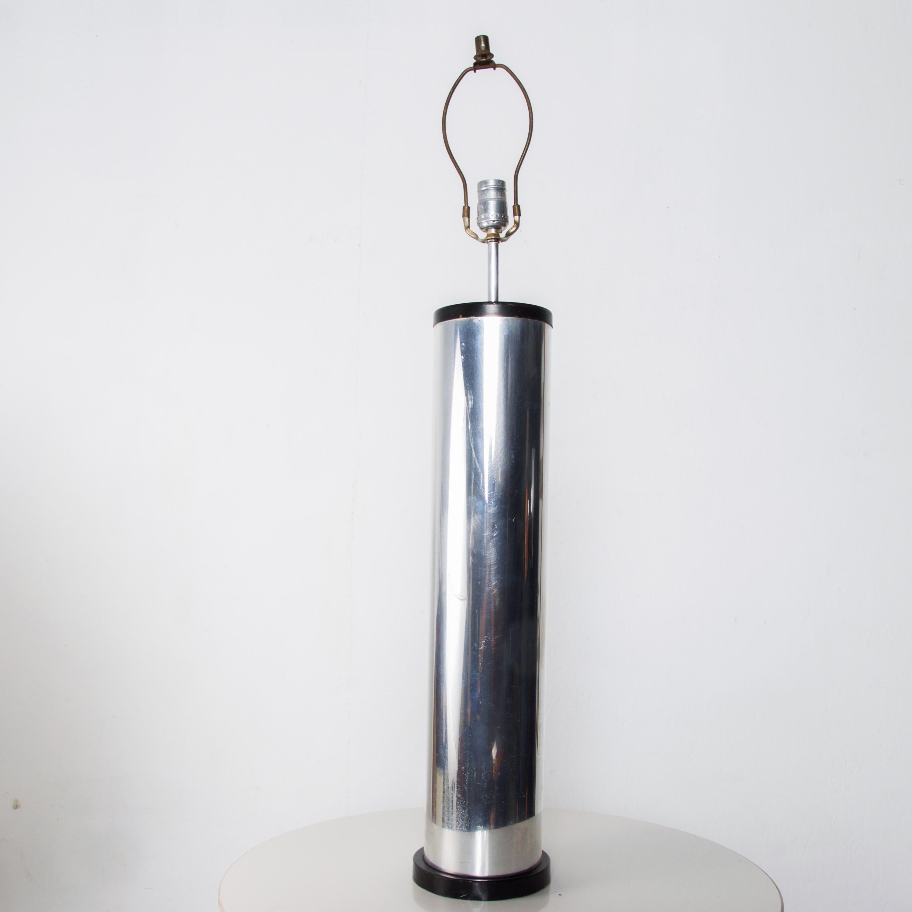 1970s vintage modern chrome cylinder table lamp. Silver with black accent.
Sleek Minimalist design.
No maker label visible. Attributed to design of George Kovacs.
Dimensions: 28 1/2