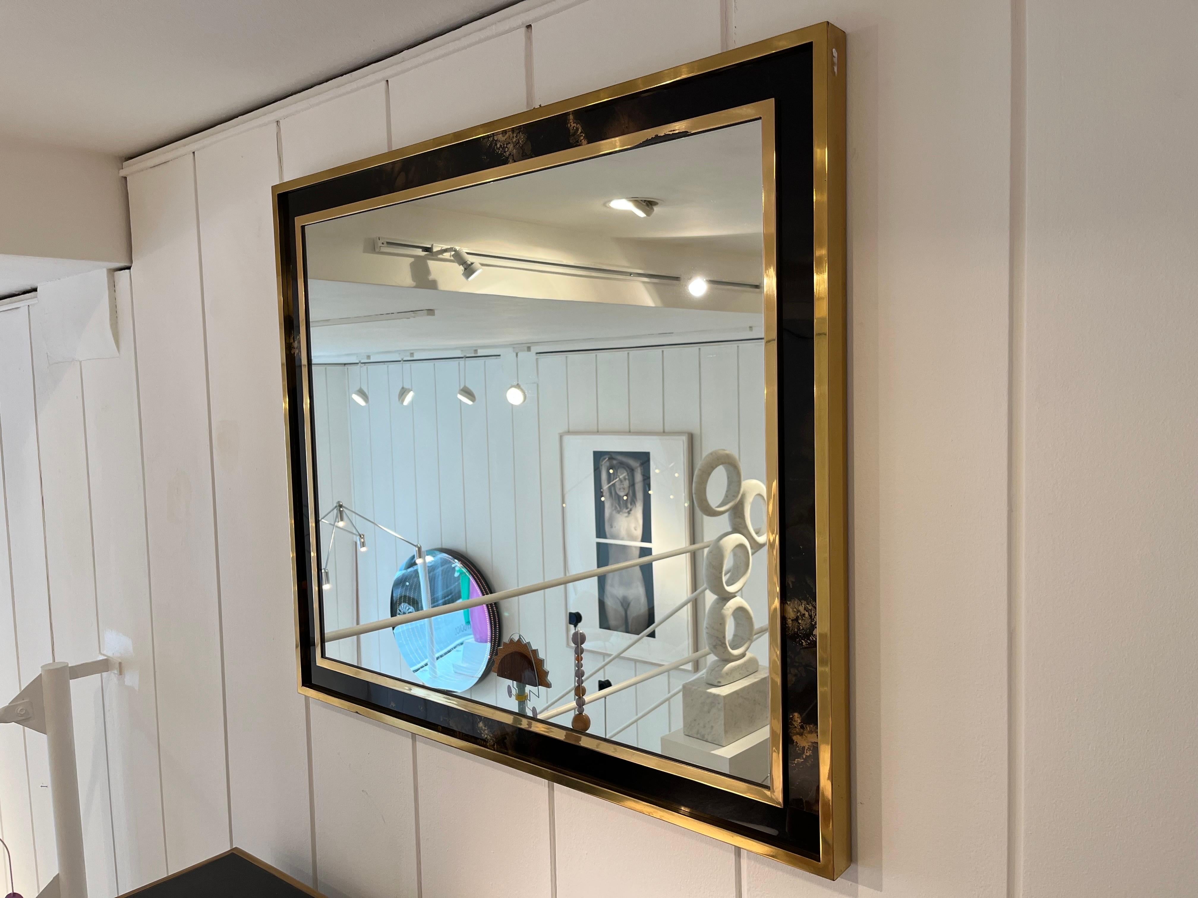1970s mirror by Maison Jansen
Brass with golden leaf lacquered wood.

 
