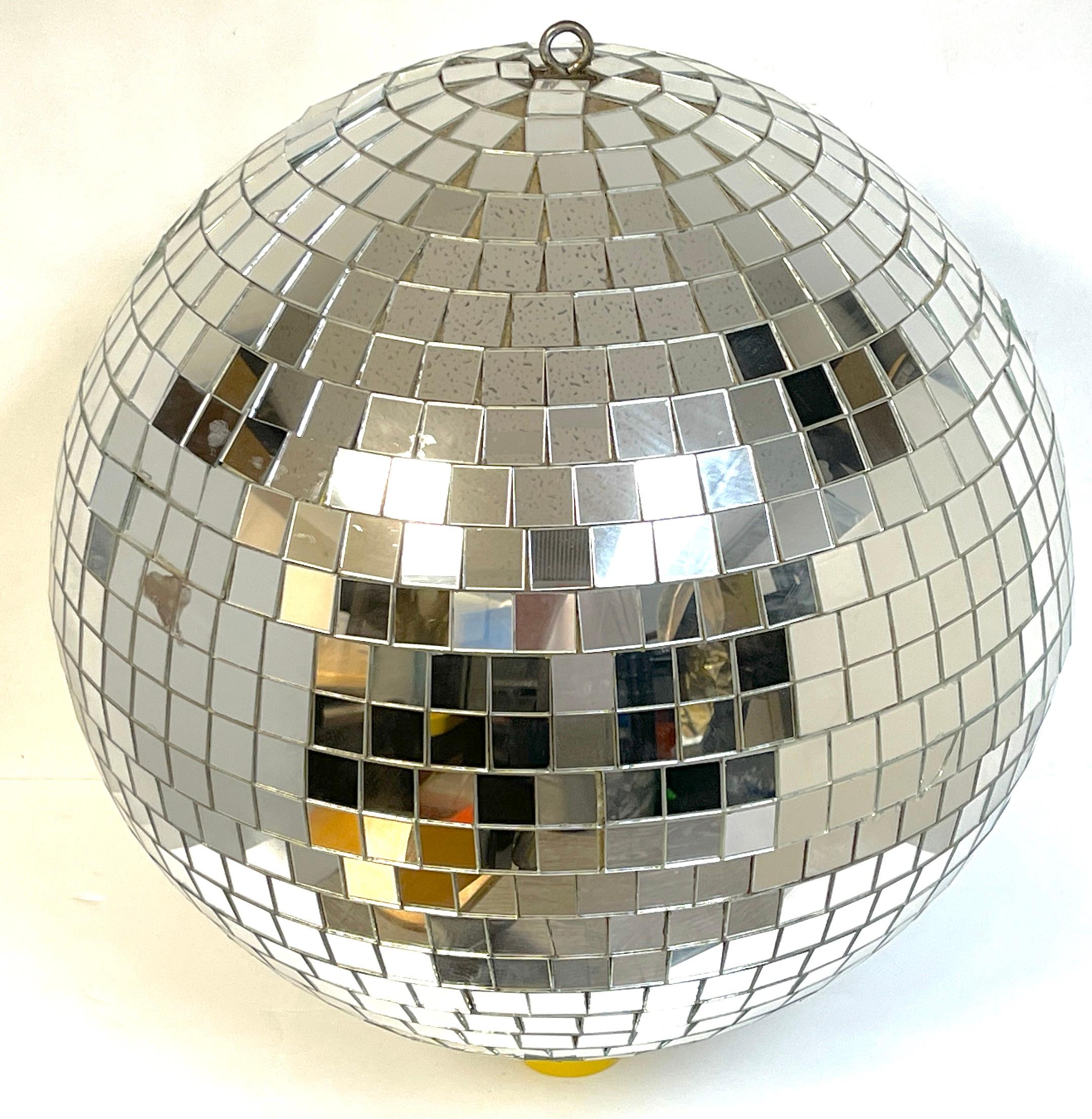 1970s Mirrored disco ball 
22-inch Round x 21-inch high = 70-inch circumference 
USA, Attributed to Omega National Products, Circa 1970s

A fine and rare surviving example of the 1970s, Structurally sound, showing signs of multiple uses, some