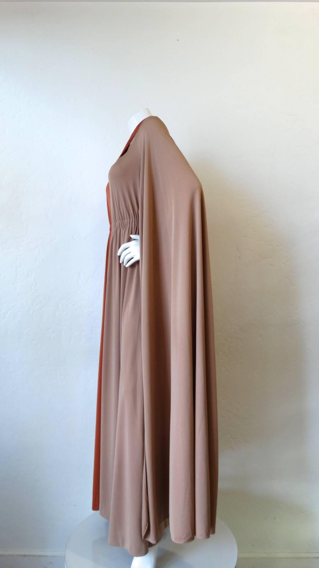The Ultimate 1970s dramatic sleeved gown from California vintage label Miss Elliette! Made of a silky two toned fabric, one side of the dress a rich taupe color contrasted by brick orange on the opposite. Incredible extra long sleeves that nearly